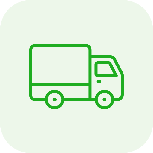 A smiling woman with short curly hair wearing a black top and a light-colored striped blazer standing in front of a glass wall.