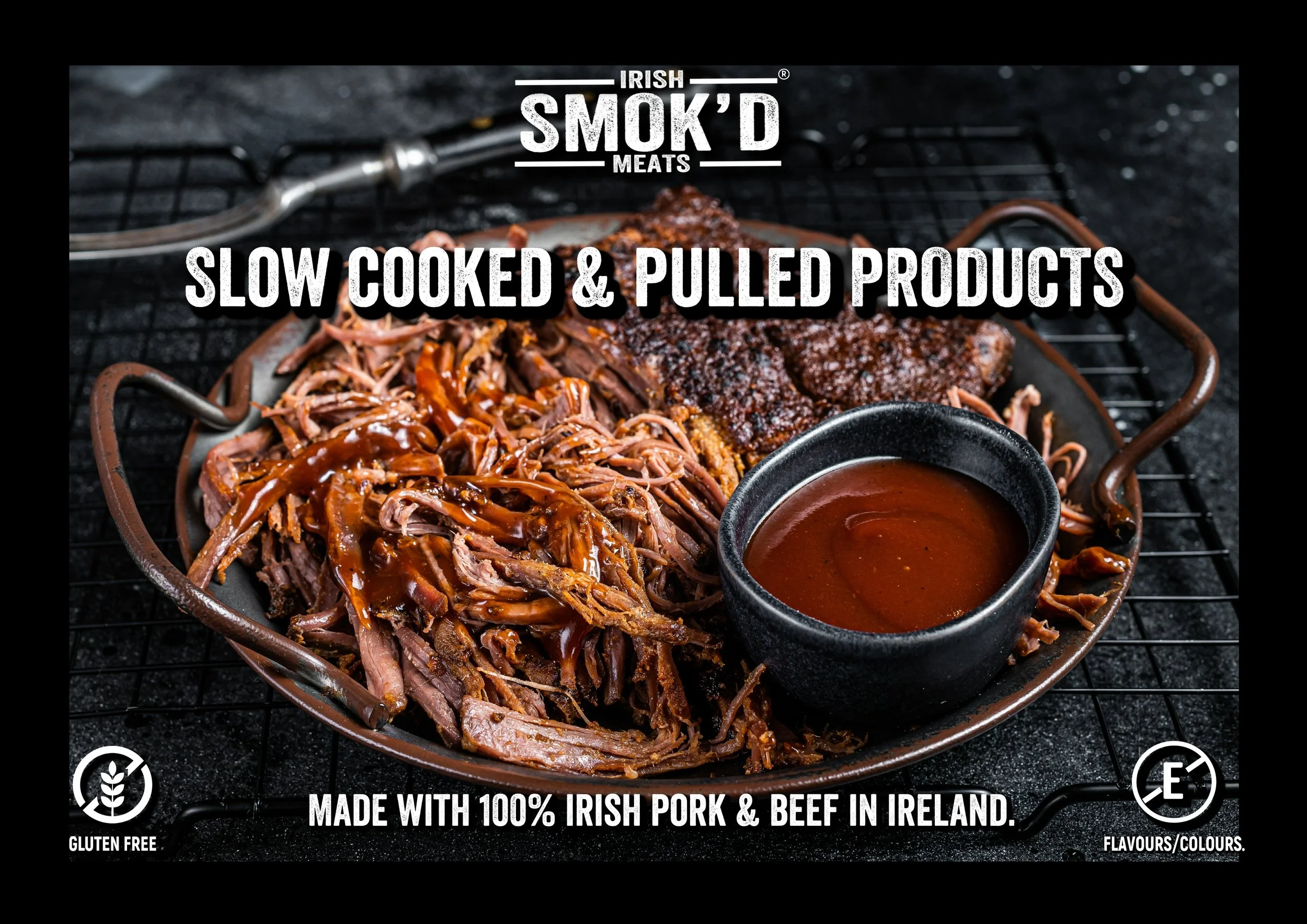 A plate of shredded pulled pork with barbecue sauce, a piece of smoked meat, and a small bowl of barbecue sauce on a black surface, with text overlay about Irish smoked meats and gluten-free, Irish origin.