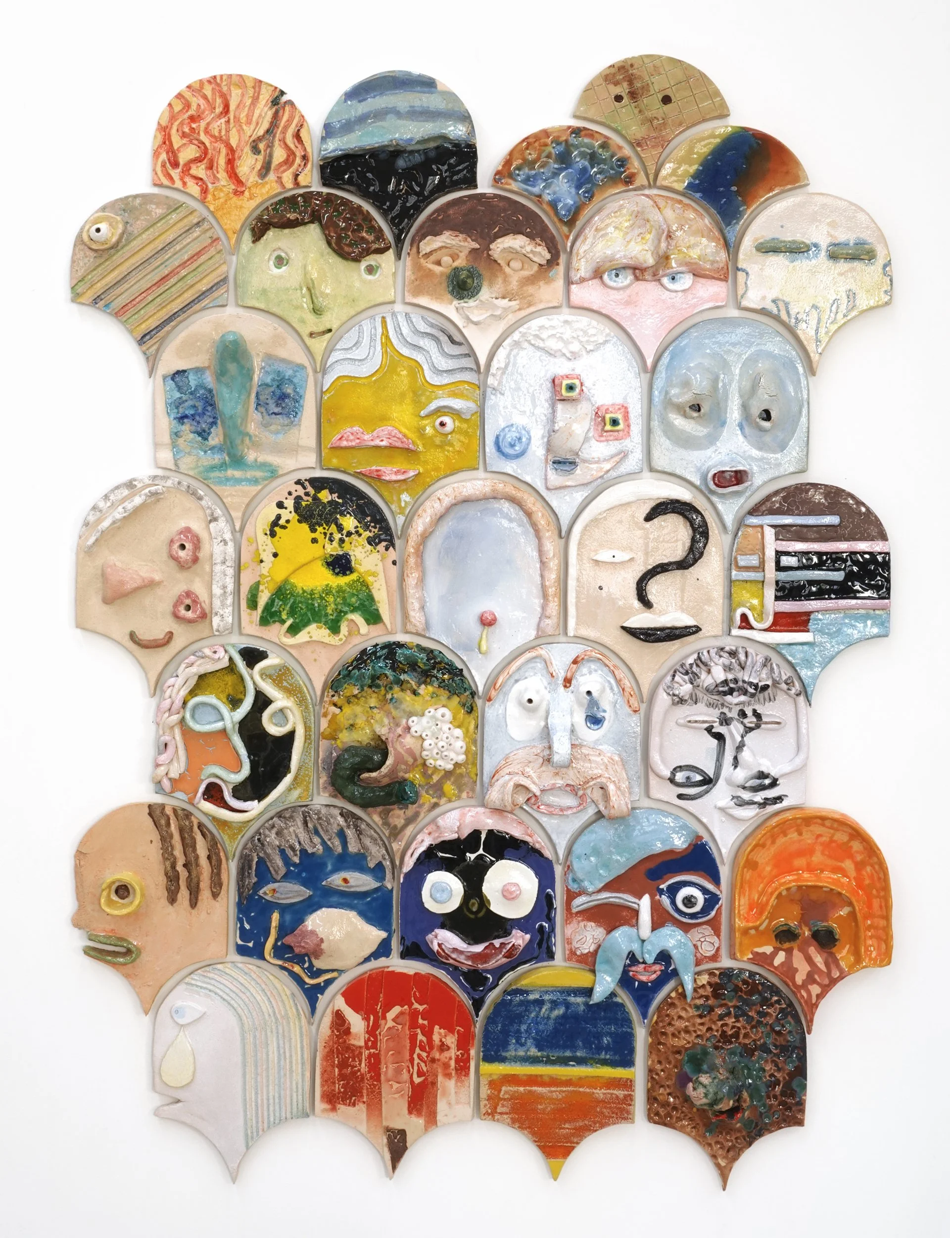 Gelitin, All for All, 2025, ceramic installation of stacked faces at Perrotin gallery on the Lower East Side, New York.