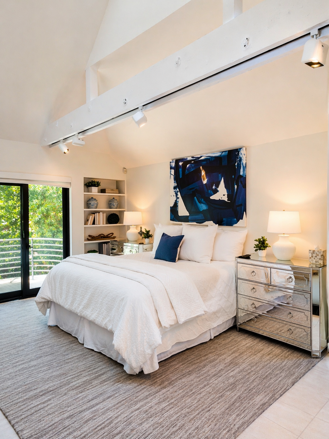 Modern coastal bedroom with abstract art.png