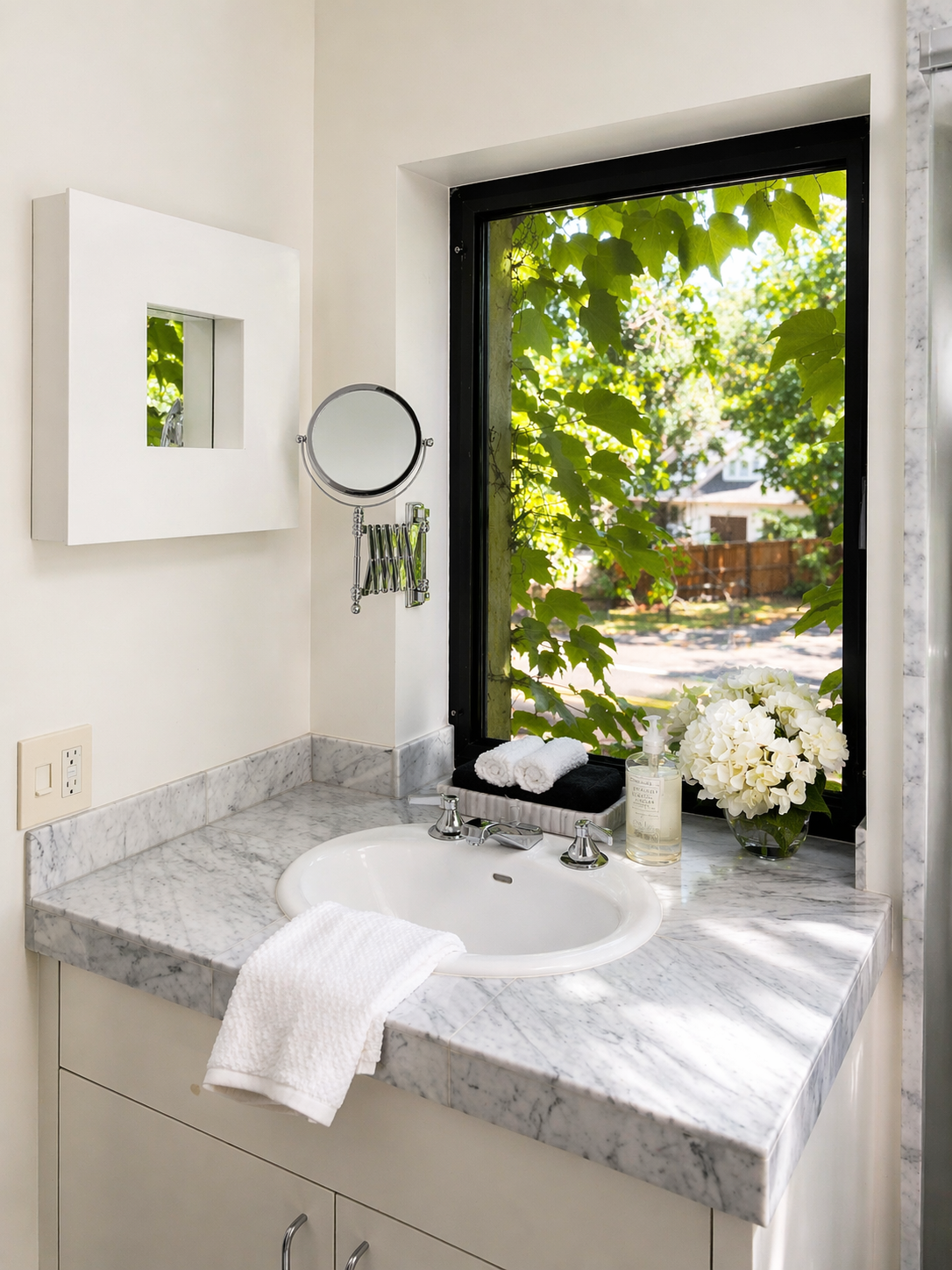 Minimalist bathroom with lush greenery view.png