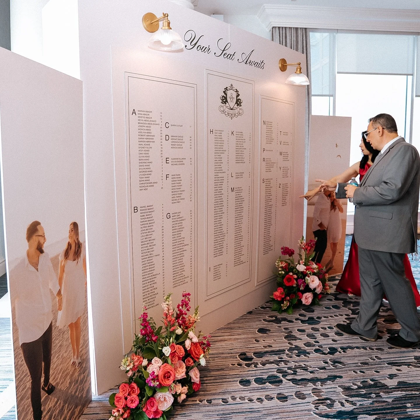Custom details from the moment your guests enter. 
The seating chart display was a great way to make use of Rebecca and Mina&rsquo;s engagement photos and add a statement piece to the space. We used the custom logo from their invitation suite across 