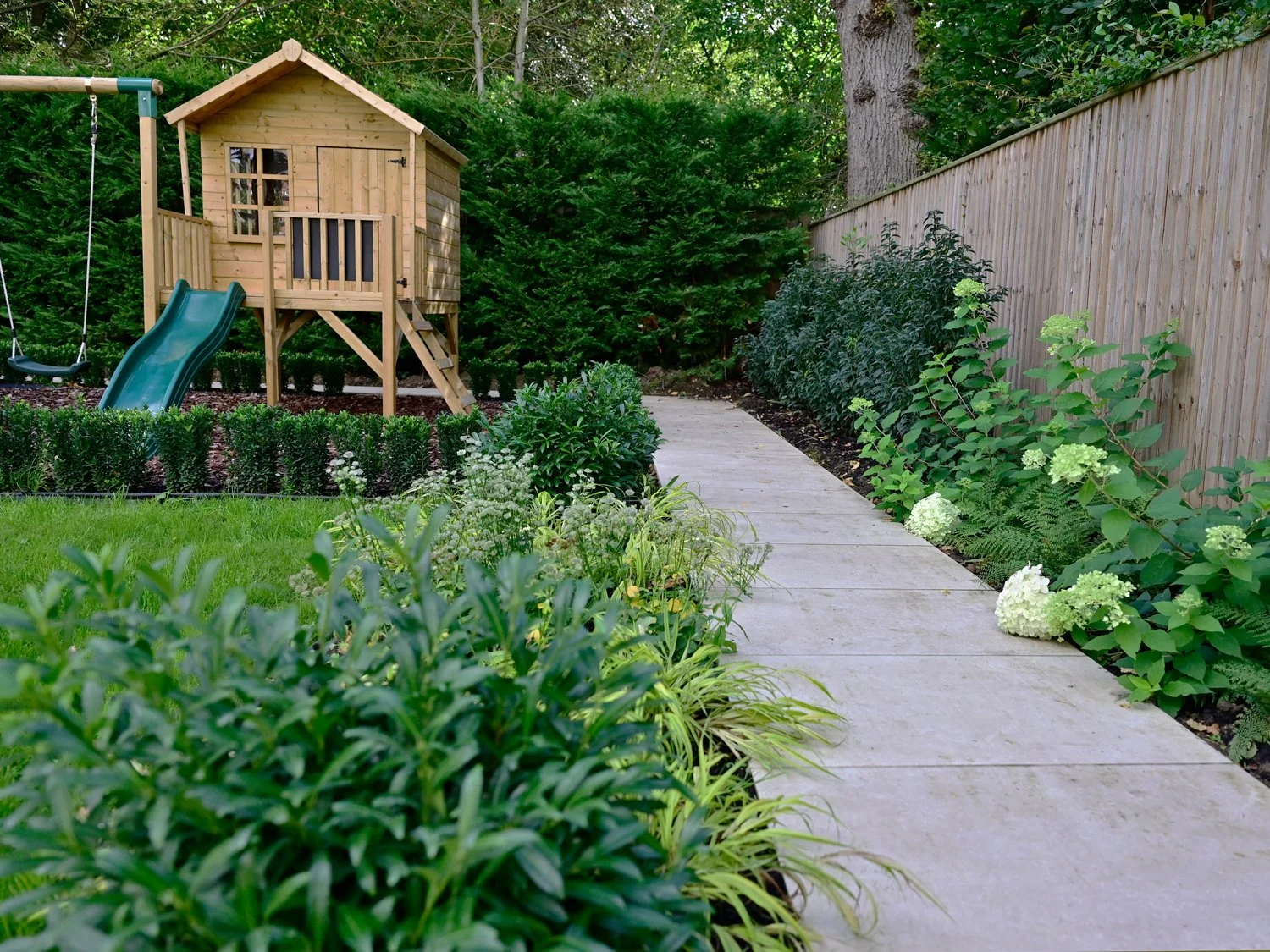 Children's play area surrounded by planting