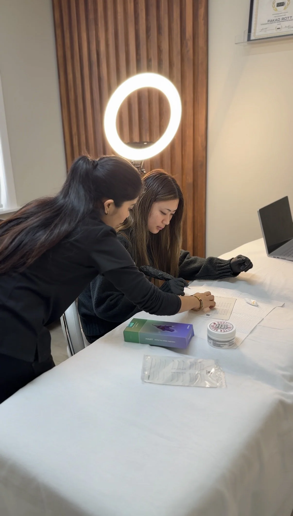 OKAPP's lead beautician guiding a lady during a training session for cosmetic treatments