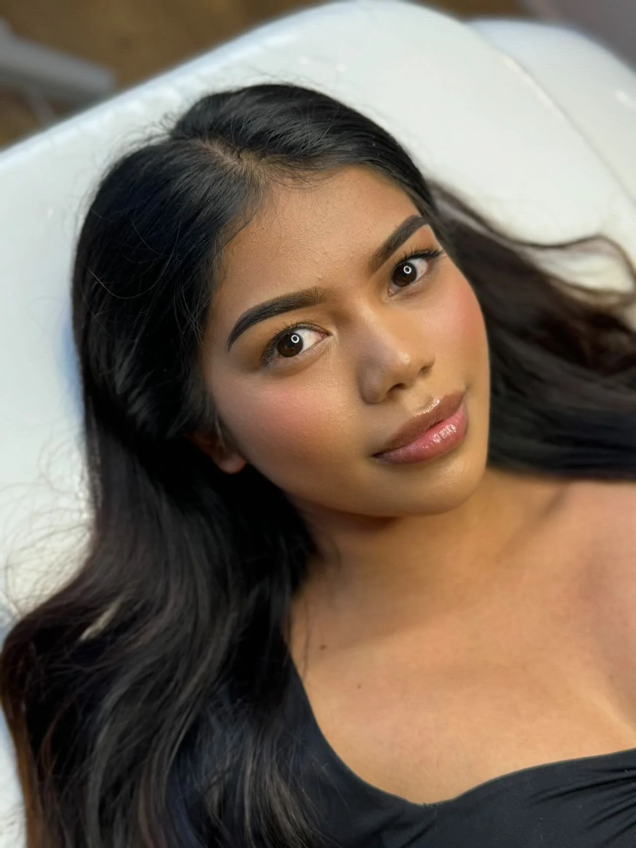 A woman with long dark hair after OKAPP's Cosmetic Eyebrow Tattoo