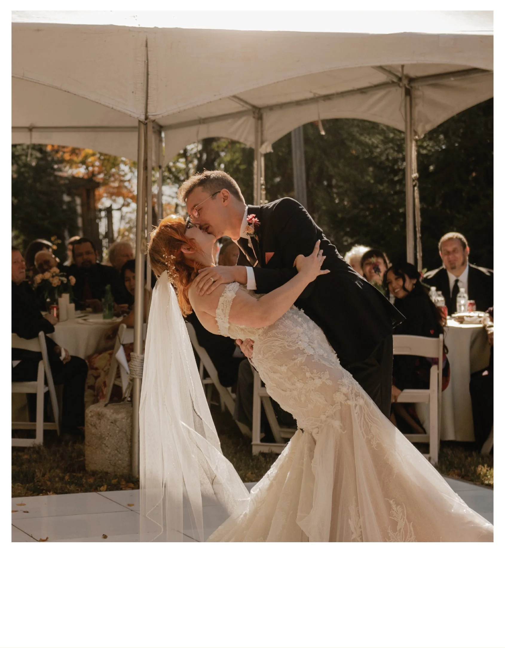A bride and groom dancing at their wedding reception, with guests seated at tables under a white canopy in the background at a private residence in Independence, Missouri.