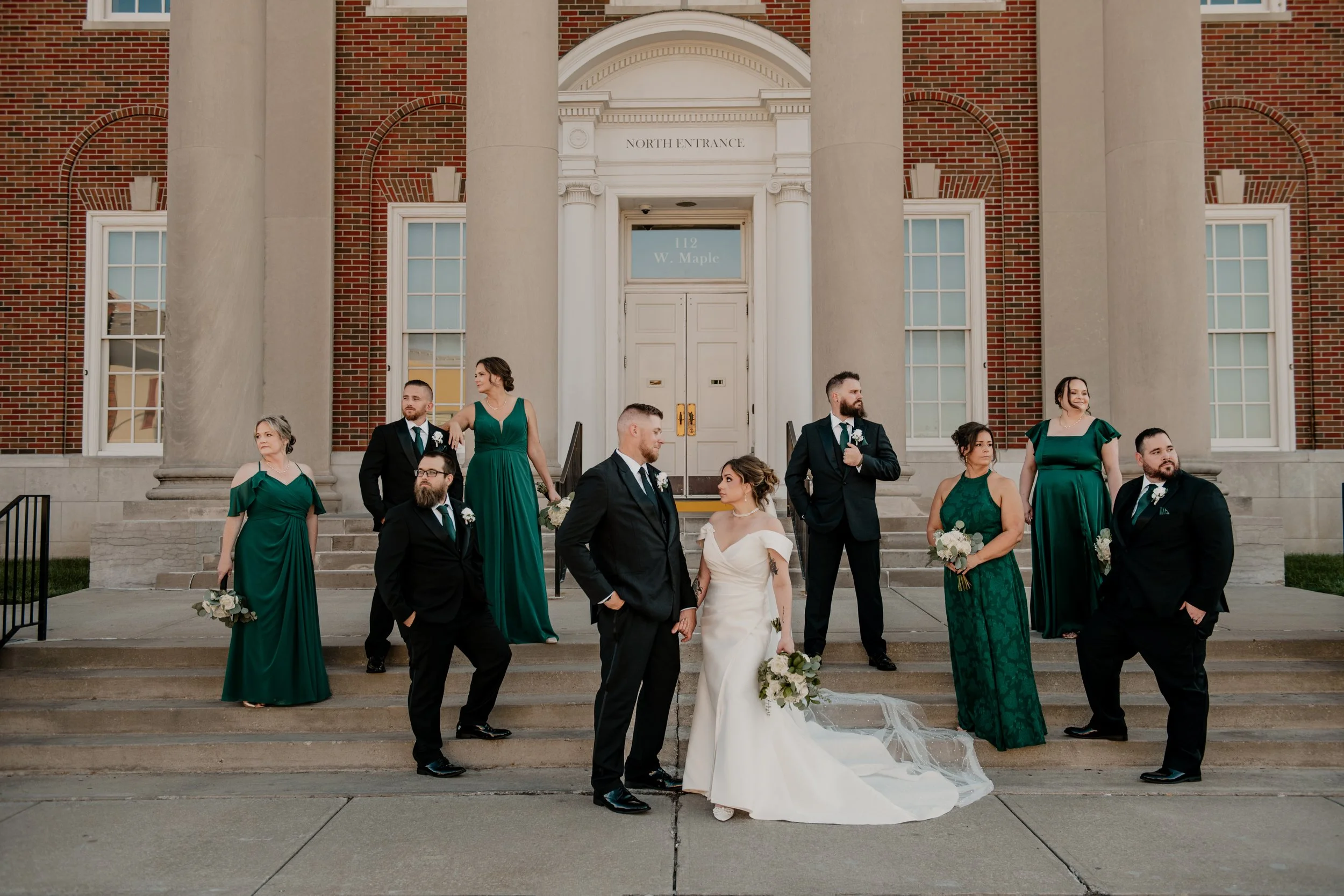 A wedding party posing outside of the Independence, Missouri court house