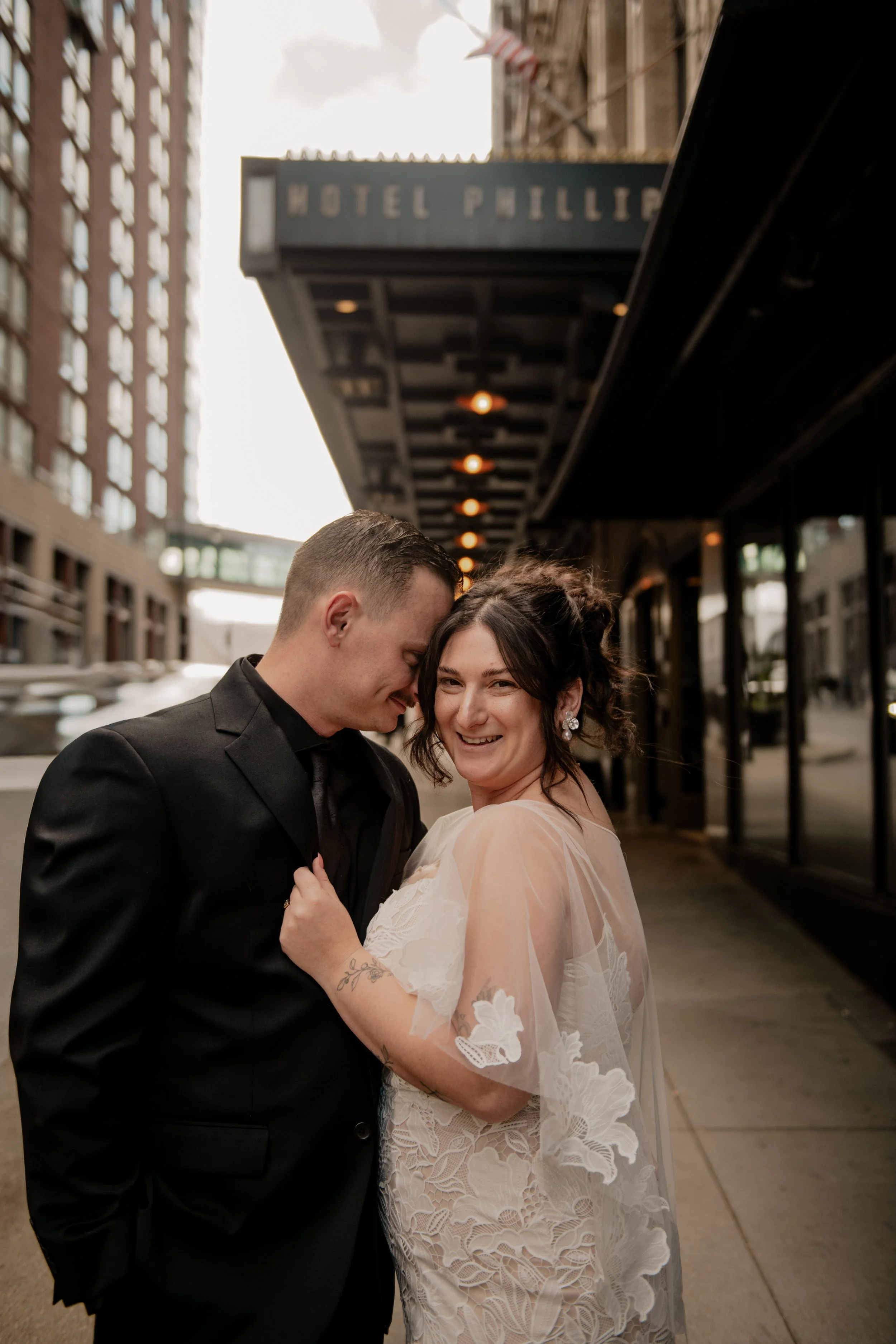 A newlywed portrait taken outside of Hotel Phillip in Kansas City, Missouri