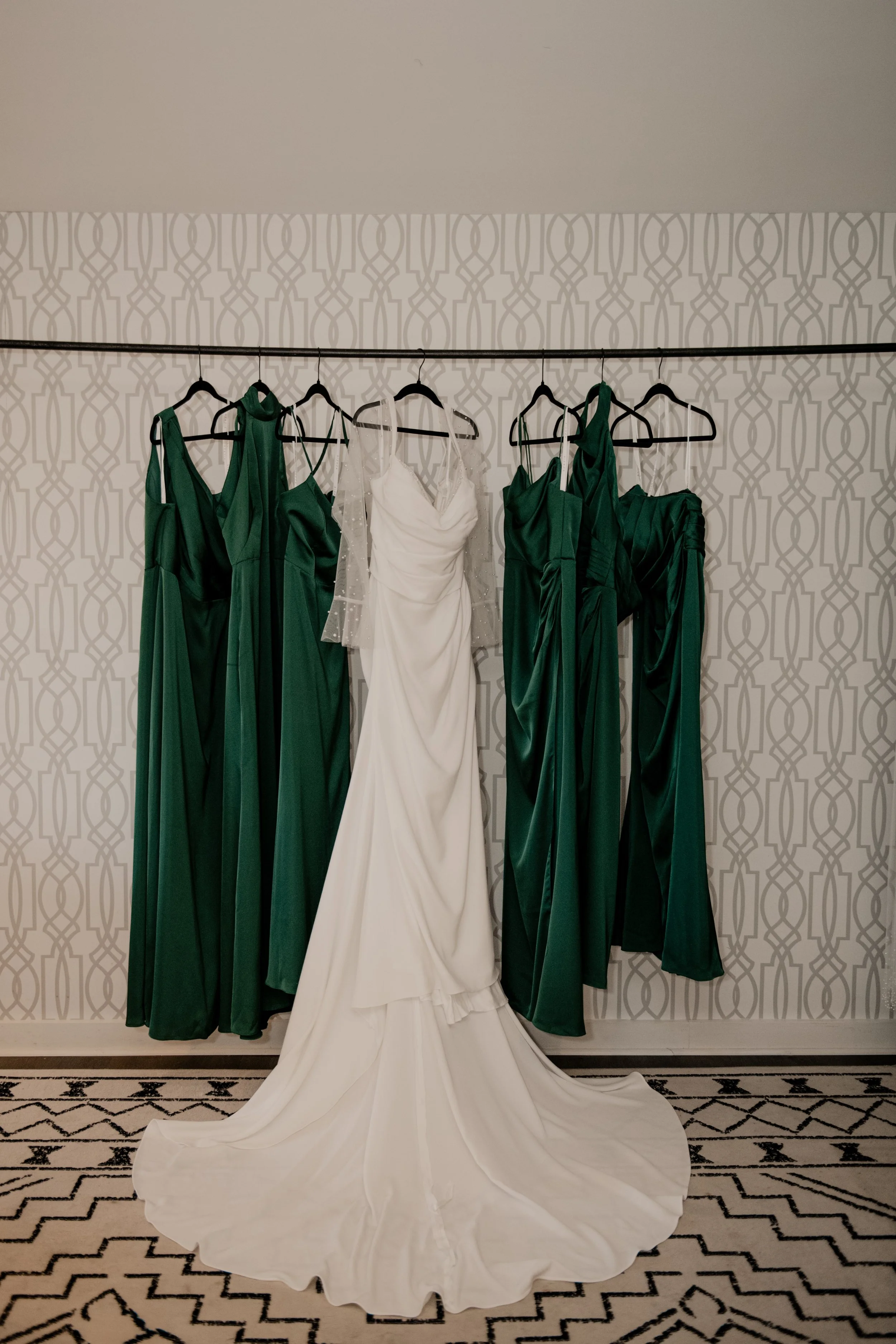 The bride's & bridemaids' dresses hanging together