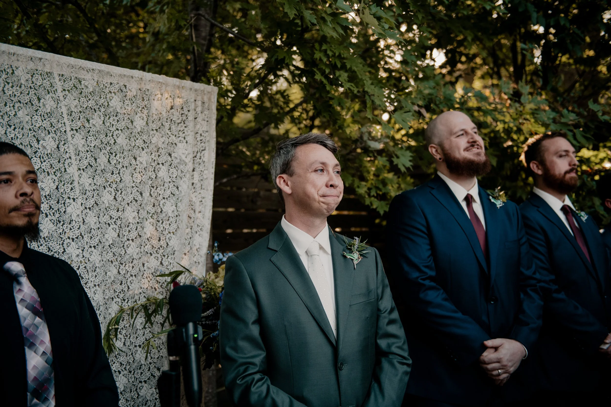 A groom looking at his bride walking down the aisle