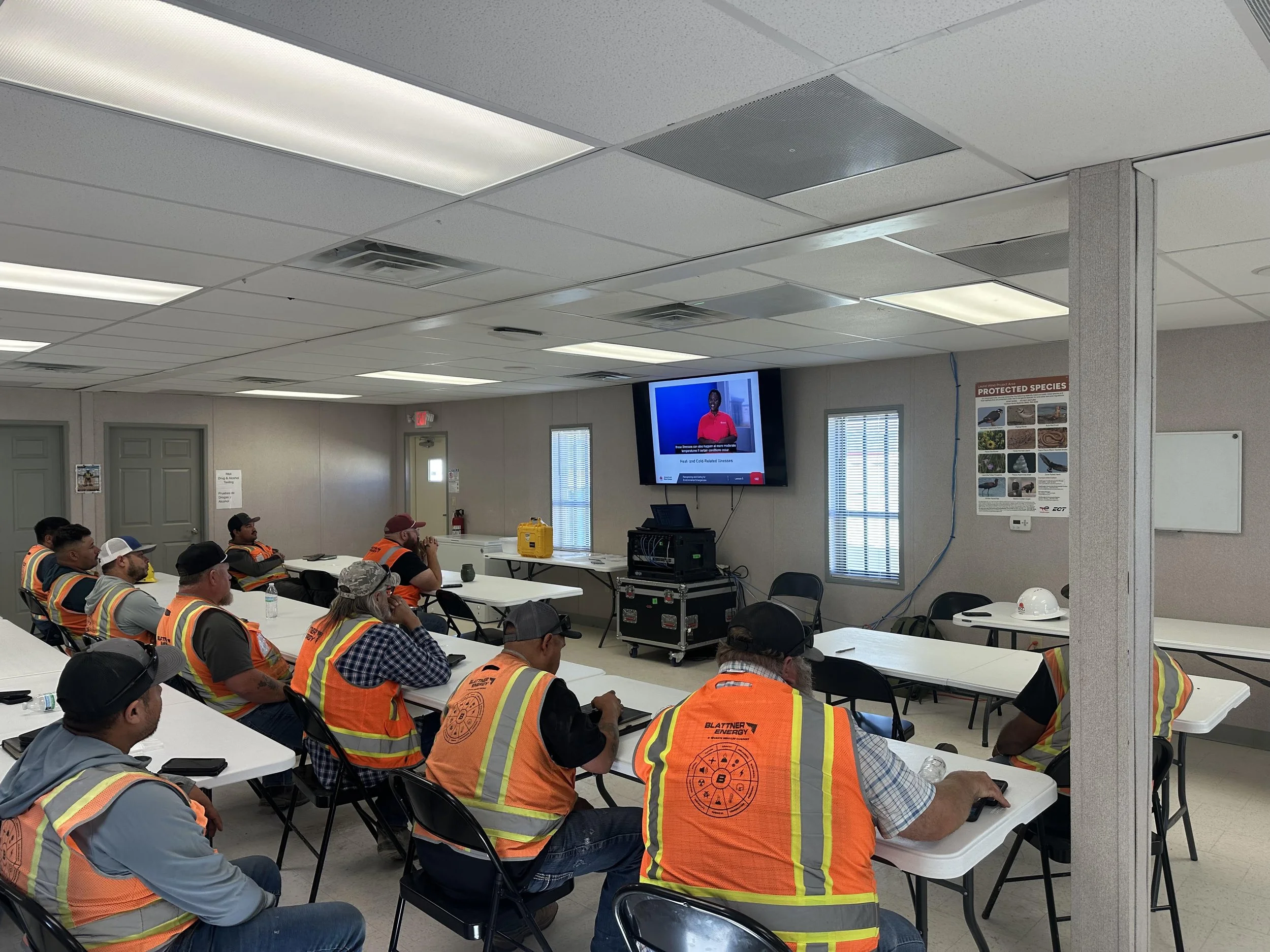 Team in high-visibility safety vests meeting on the job
