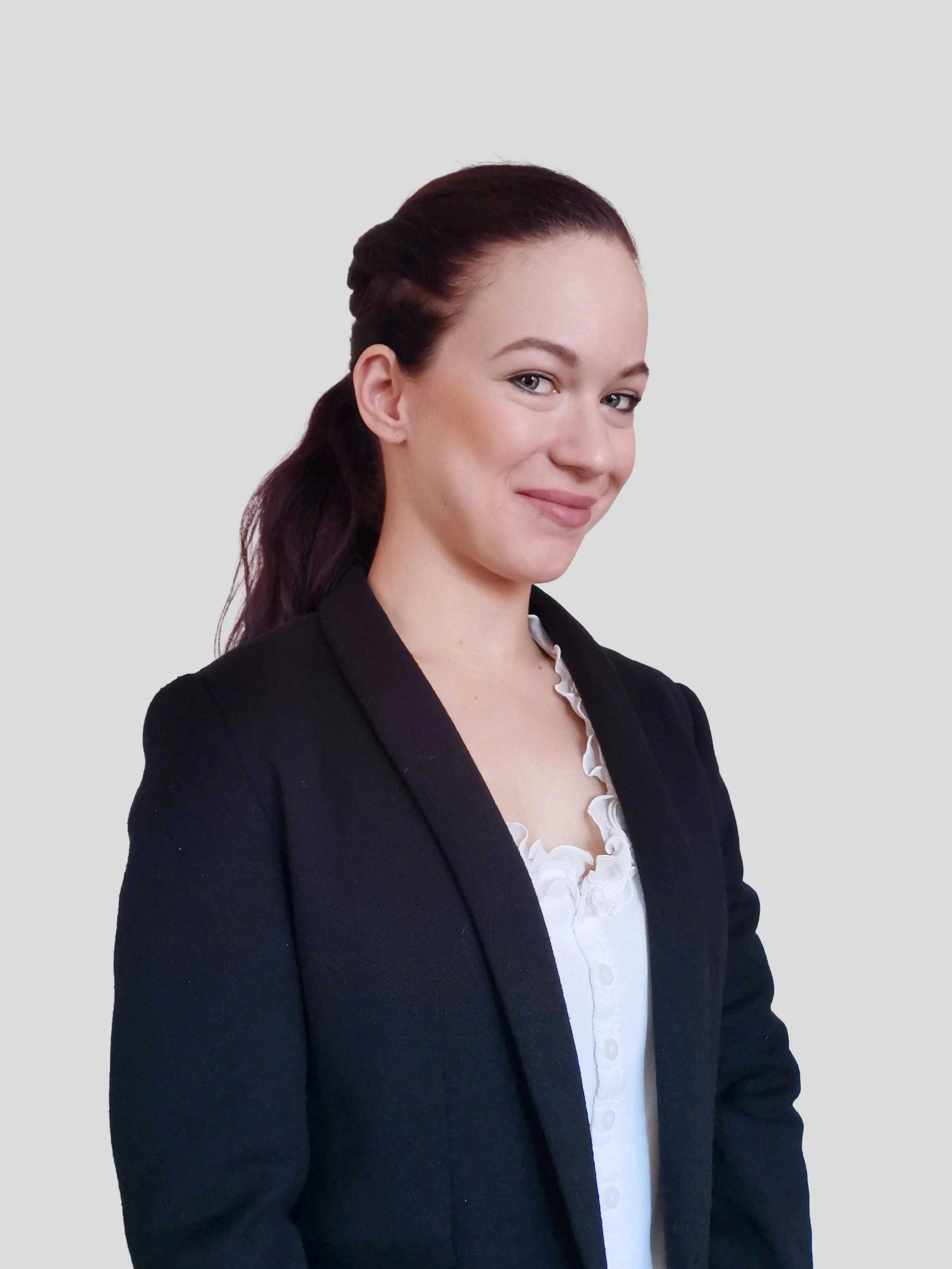 Young woman with long dark hair and white blouse.