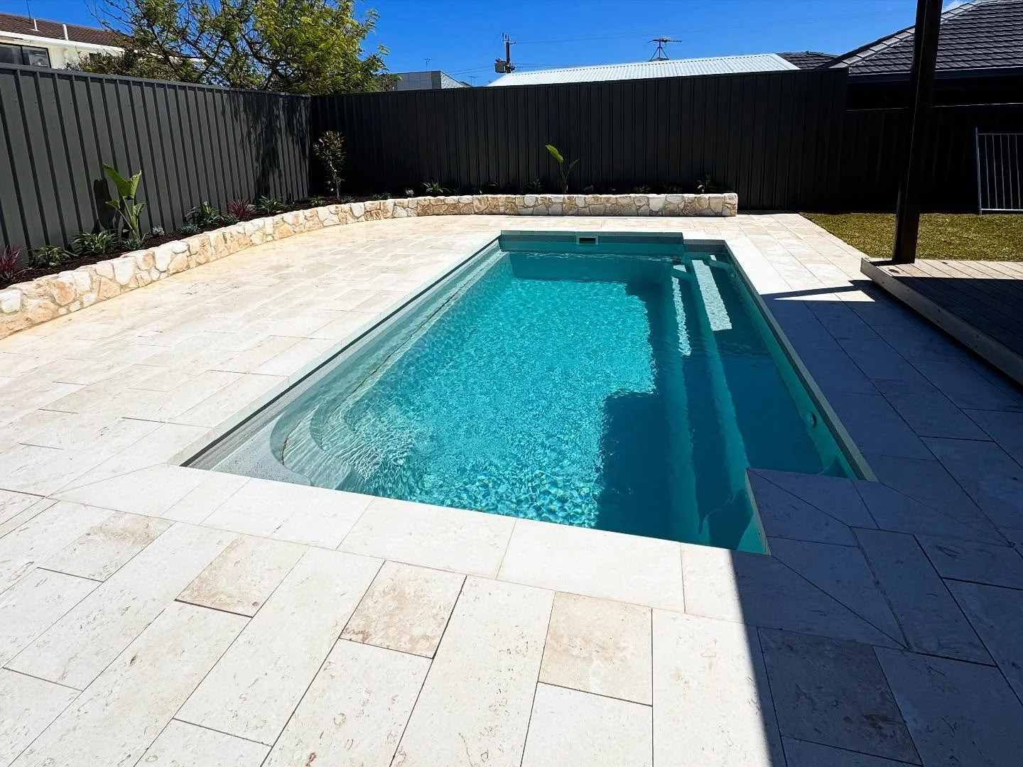 Very rewarding job completing this from start to finish.

- Paving and drop face pool coping using beige limestone.
- Sandstone veneer wall.
- Hidden pool cover box.
- Gardens, lawns, corten steel edging and irrigation.

Now an amazing backyard for t