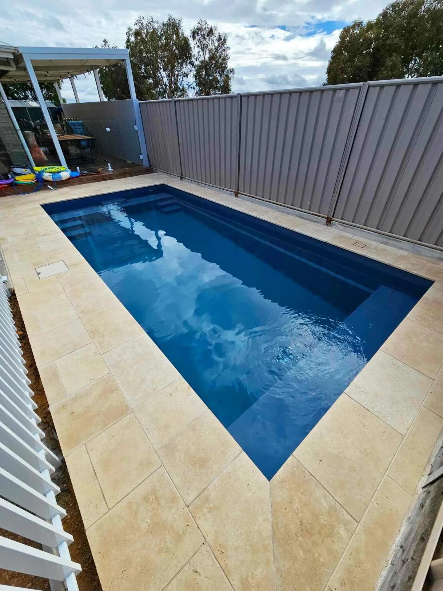 Small pool area completed from start to finish including bond beam, slab pour, coping and paving using these travertine tiles