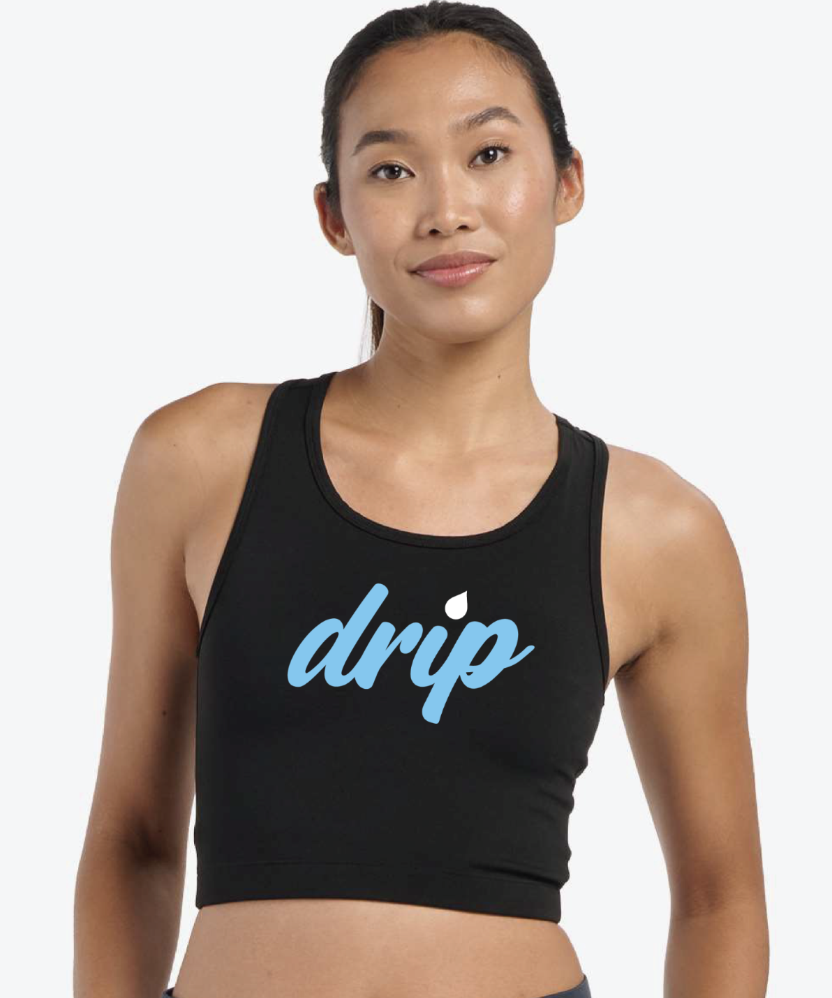 A woman wearing a black sleeveless sports top with the word 'drip' written on it in blue and white letters.