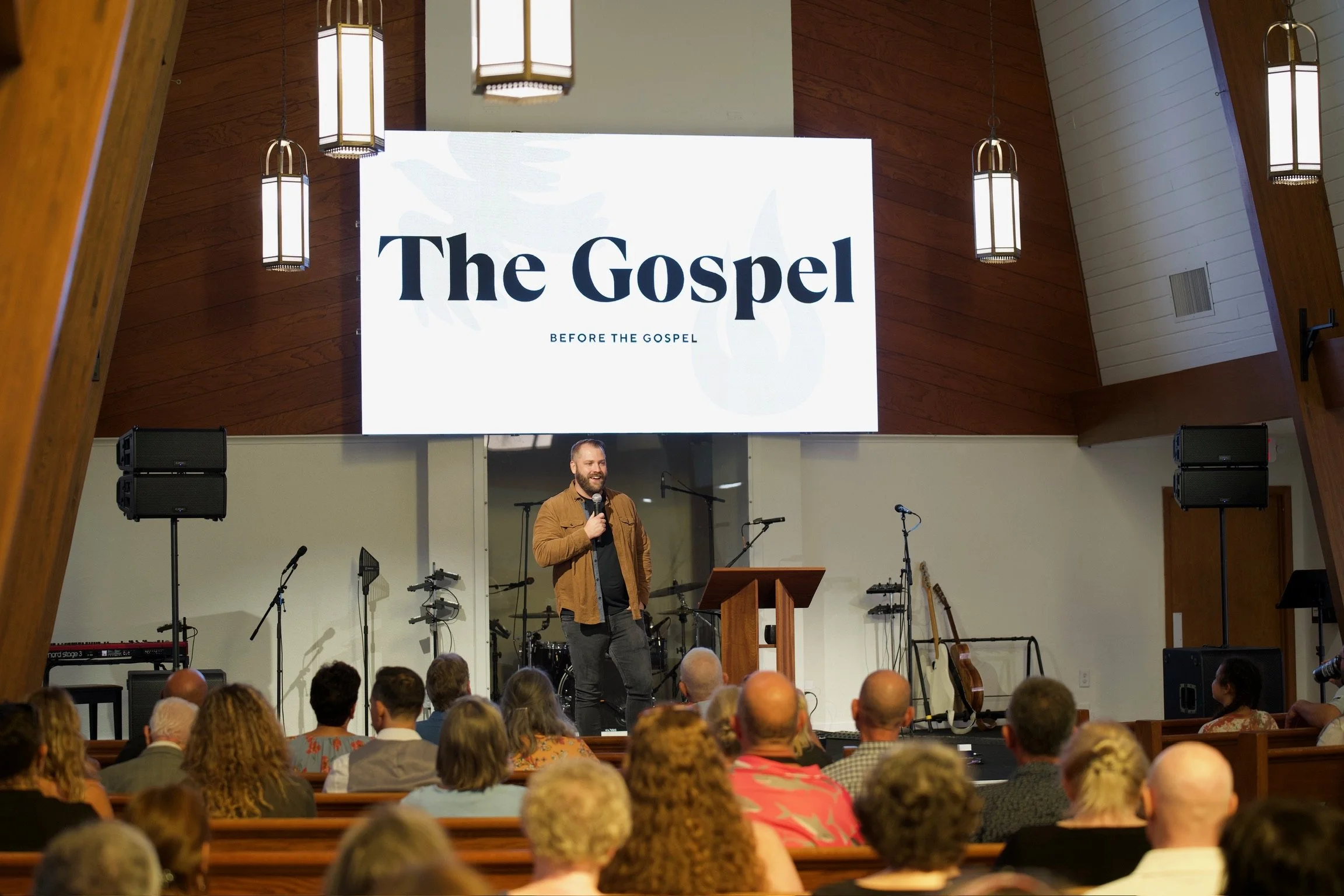 Group of people sitting in pews listening to a hope-filled sermon by Michael Swearingen at Coastline Christian Church in Sarasota, FL