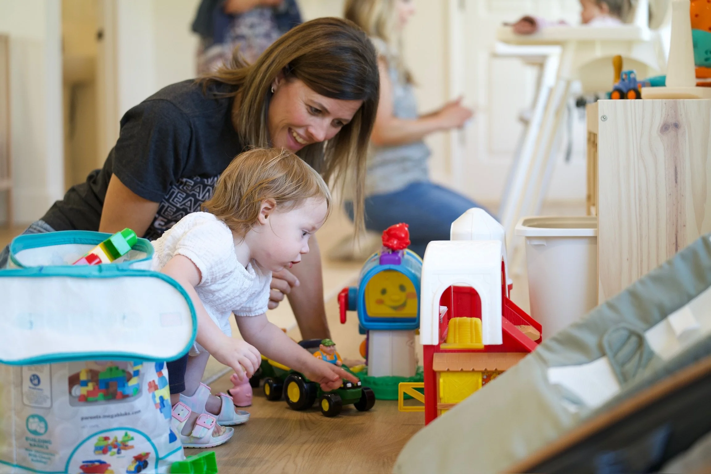 volunteer and child playing with toys at coastline church in sarasota
