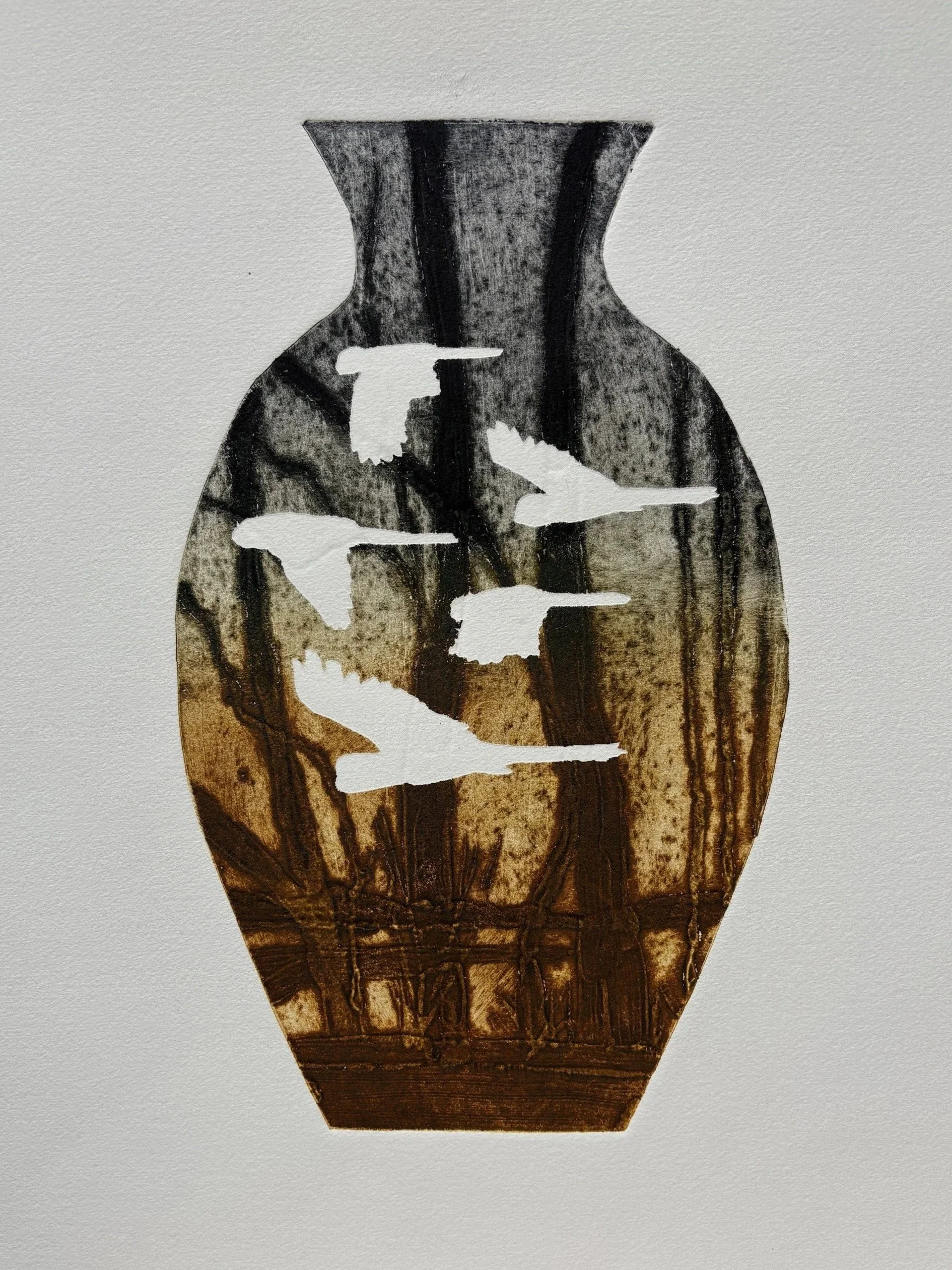 Photo of a wooden vase with white silhouette of birds flying.