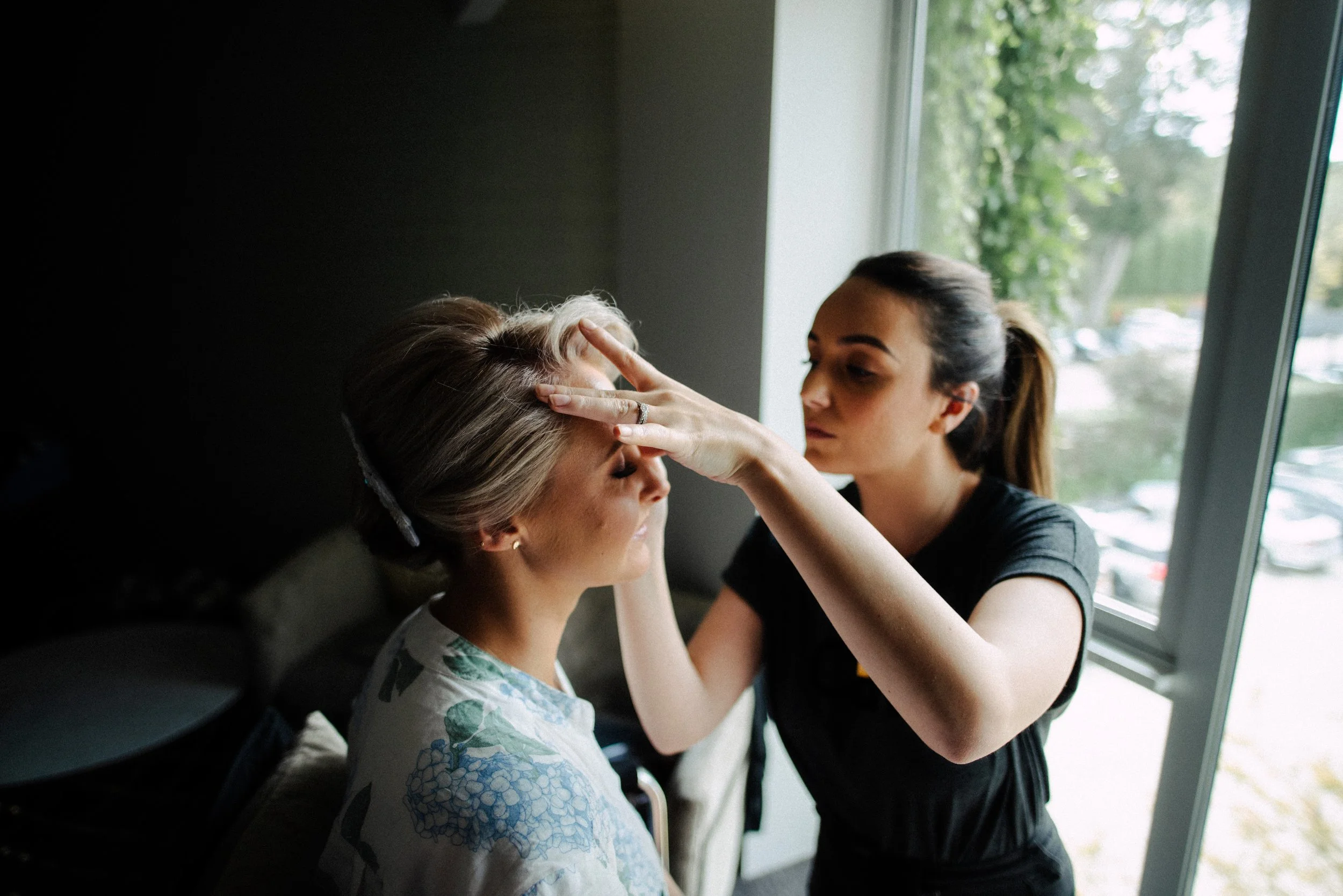 Bride getting hair and makeup done.