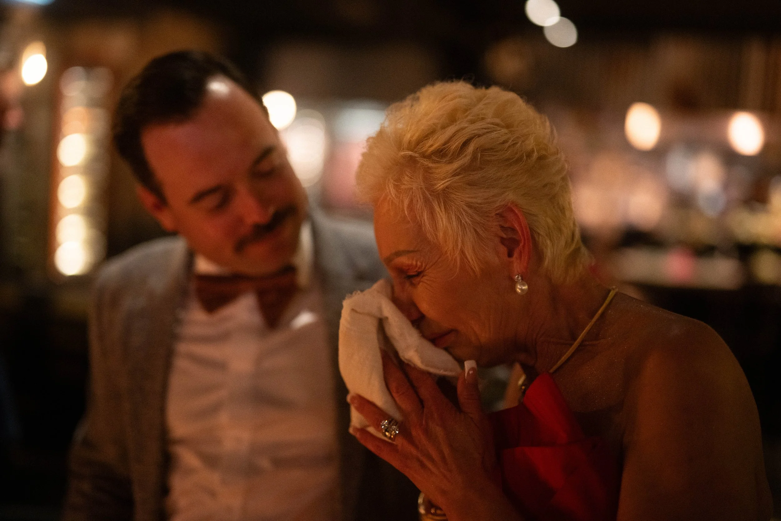 Emotional family and friends at wedding ceremony.