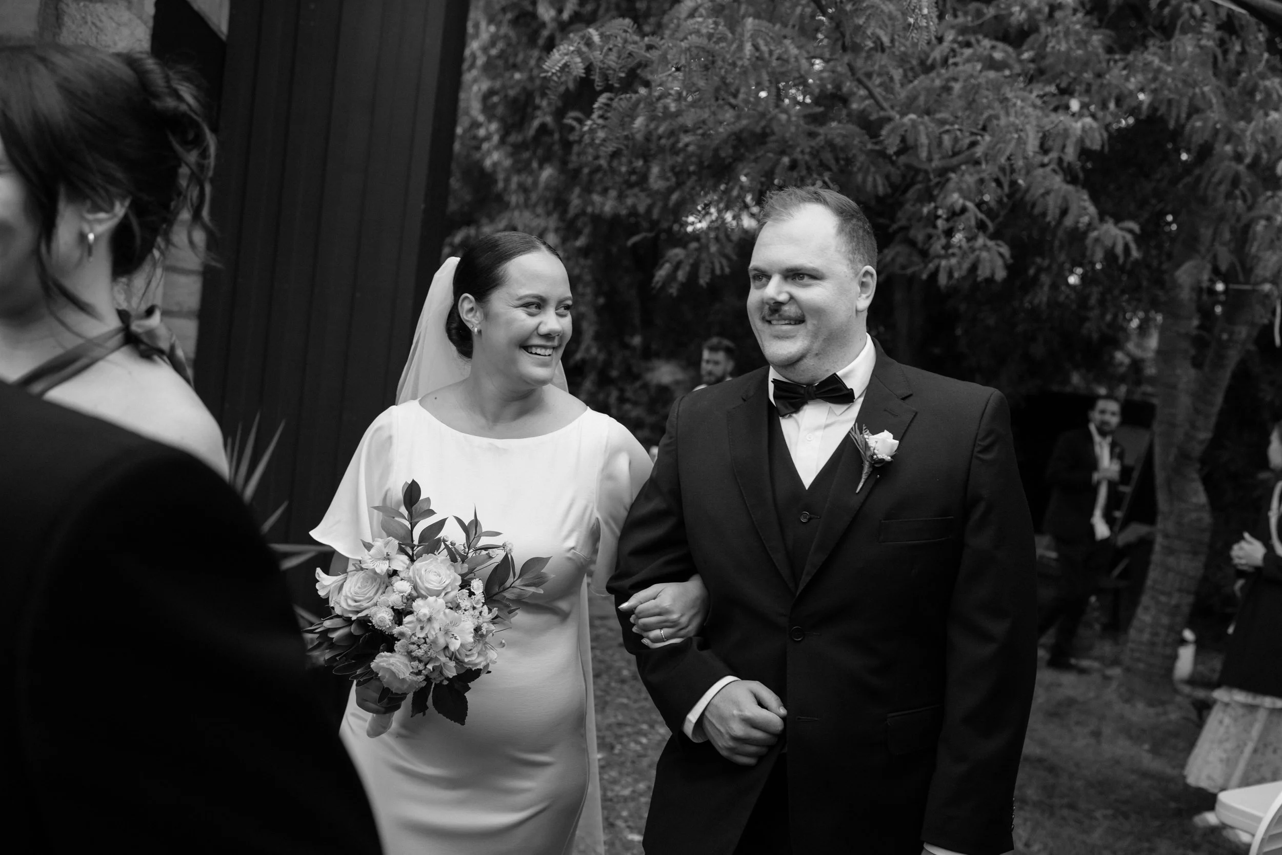 Film + Digital Wedding Photographer Christchurch - Backyard Wedding, Christchurch, Canterbury, New Zealand. Bride and groom entering their backyard wedding reception smiling at each other.