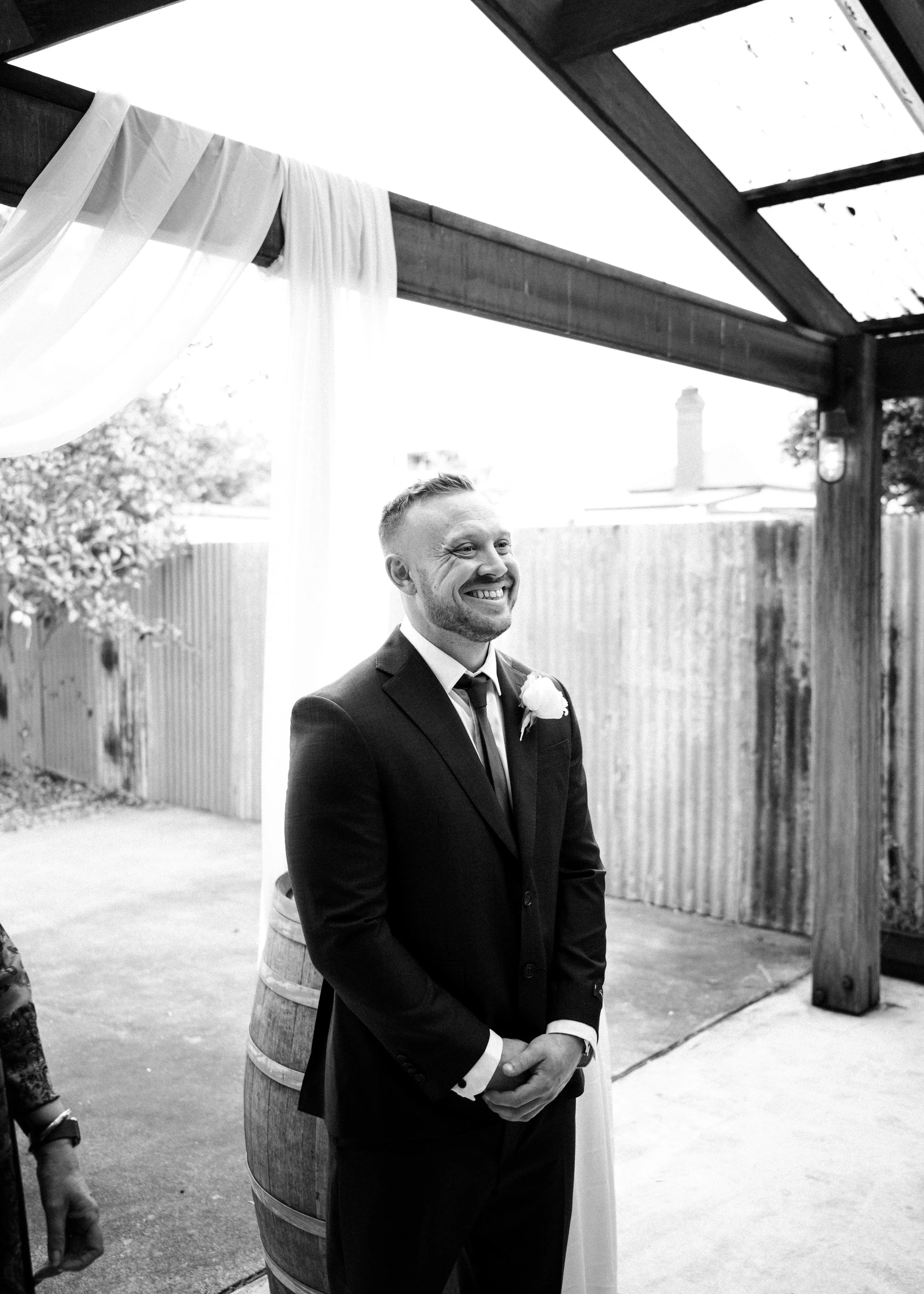 Groom smiling when seeing his bride.
