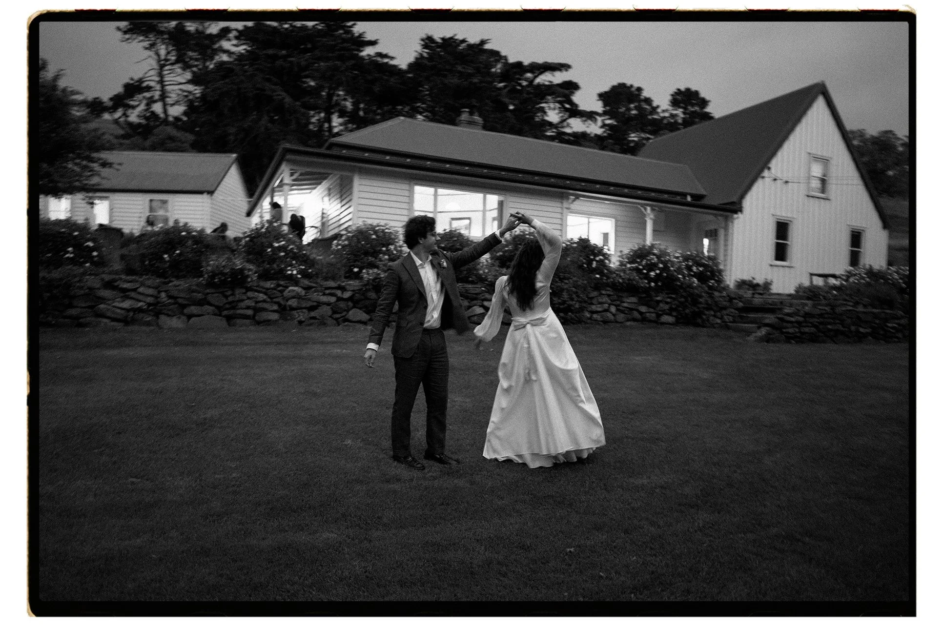 Film + Digital Wedding Photographer Christchurch - Banks Peninsula Wedding, Christchurch, Canterbury, New Zealand. Black and white photo of bride and groom’s first dance on lawn in front of victorian homestead, Accrington Farm.