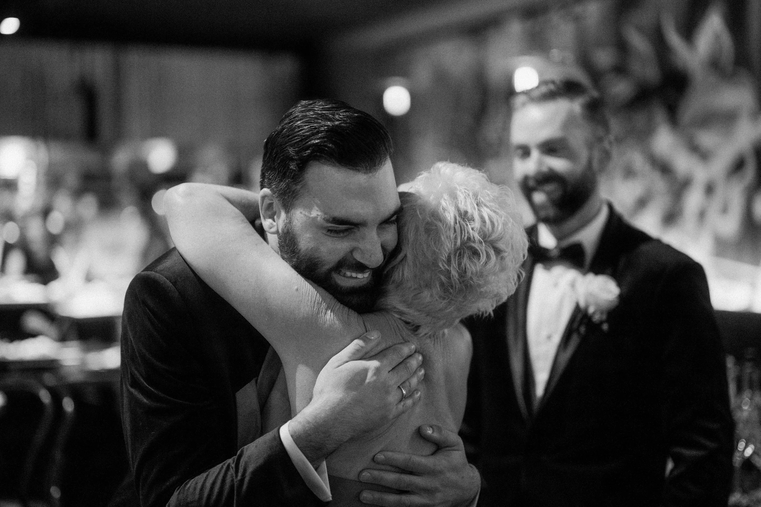 Emotional wedding photo of groom hugging his mum.