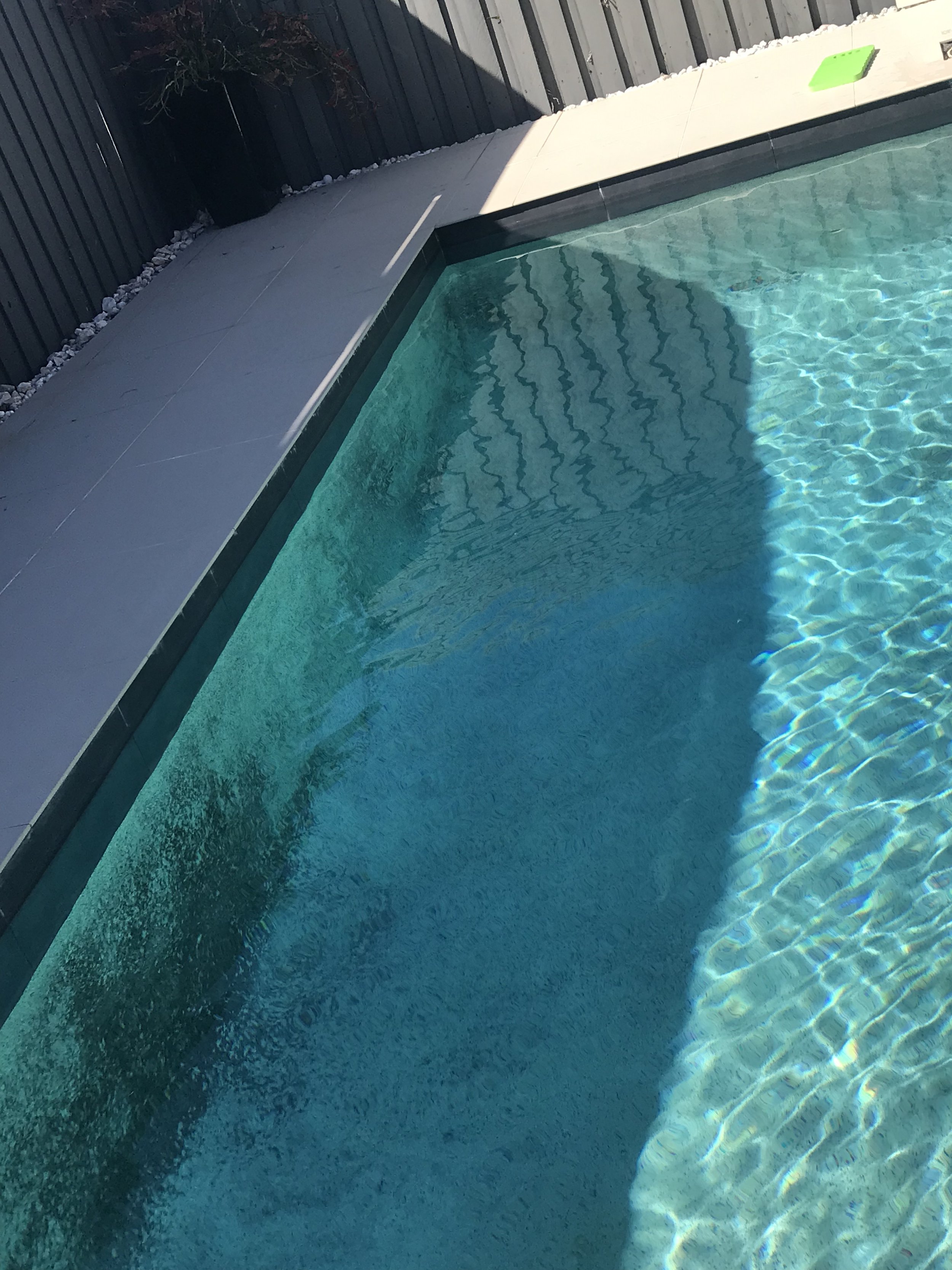 Copper staining visible on the walls and fittings of a Birtinya pool