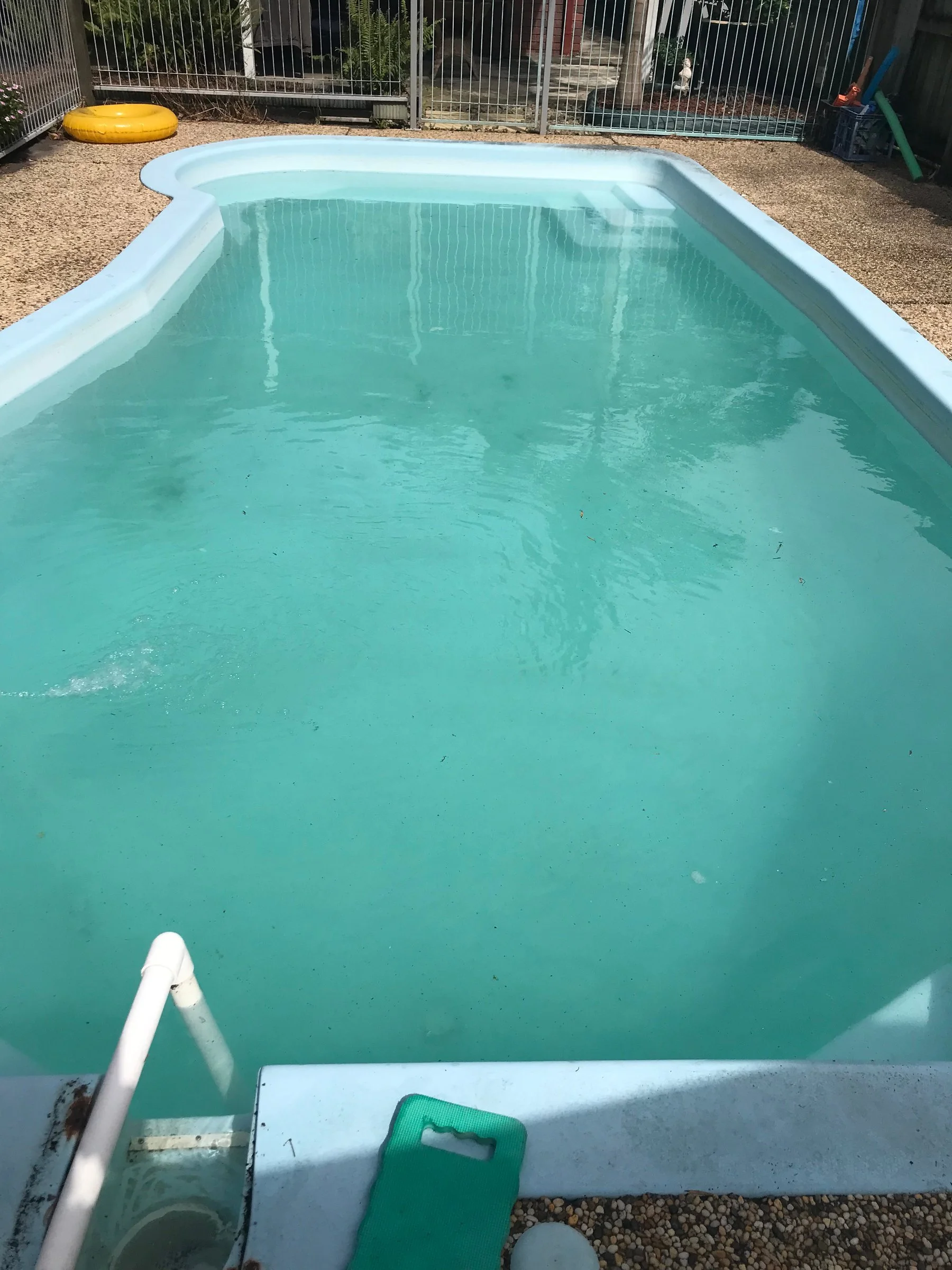 Mountain Creek pool during recovery, with pale blue-green water still cloudy.