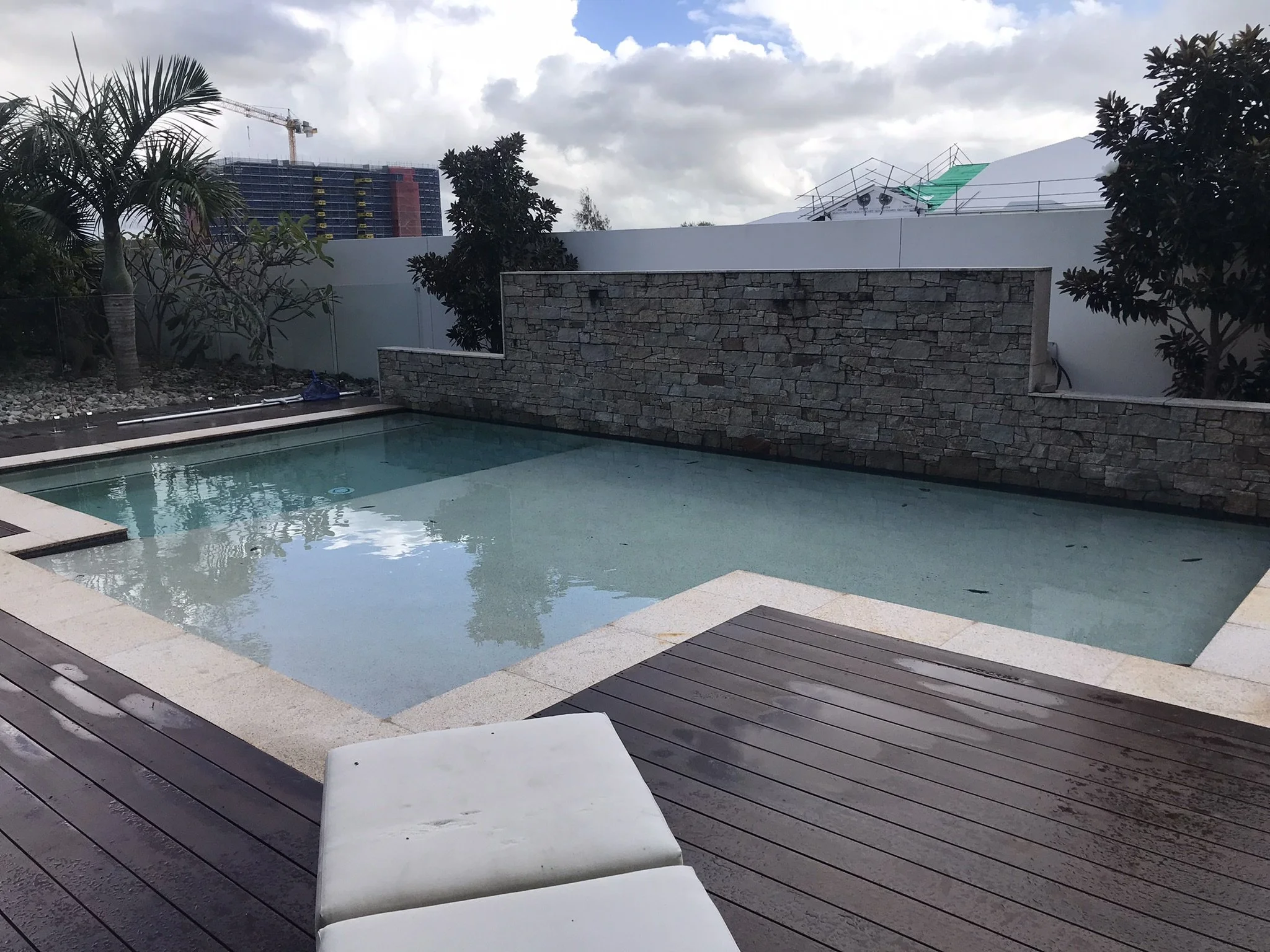 swimming-pool-stone-feature-wall-timber-deck-clarity-pool-services.jpeg