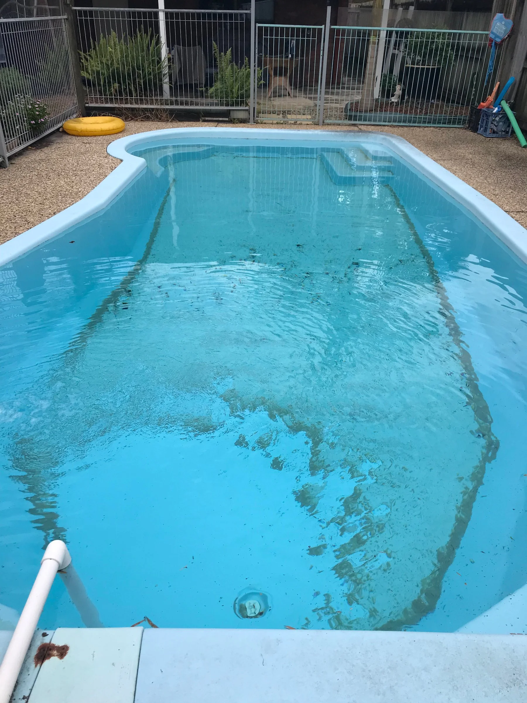 Debris settled on the Mountain Creek pool floor before vacuuming to waste.