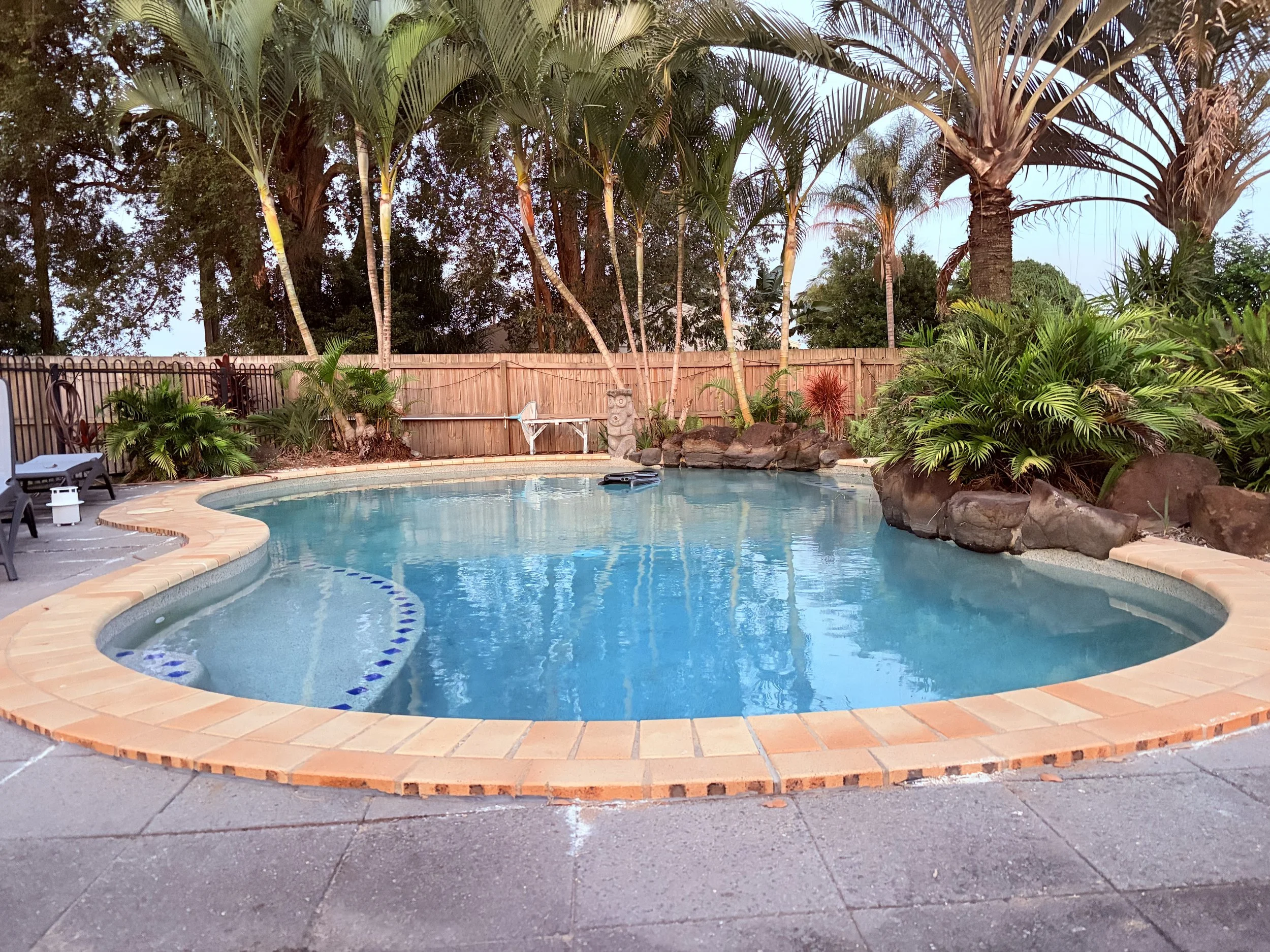 Older style residential pool in tropical garden Mountain Creek