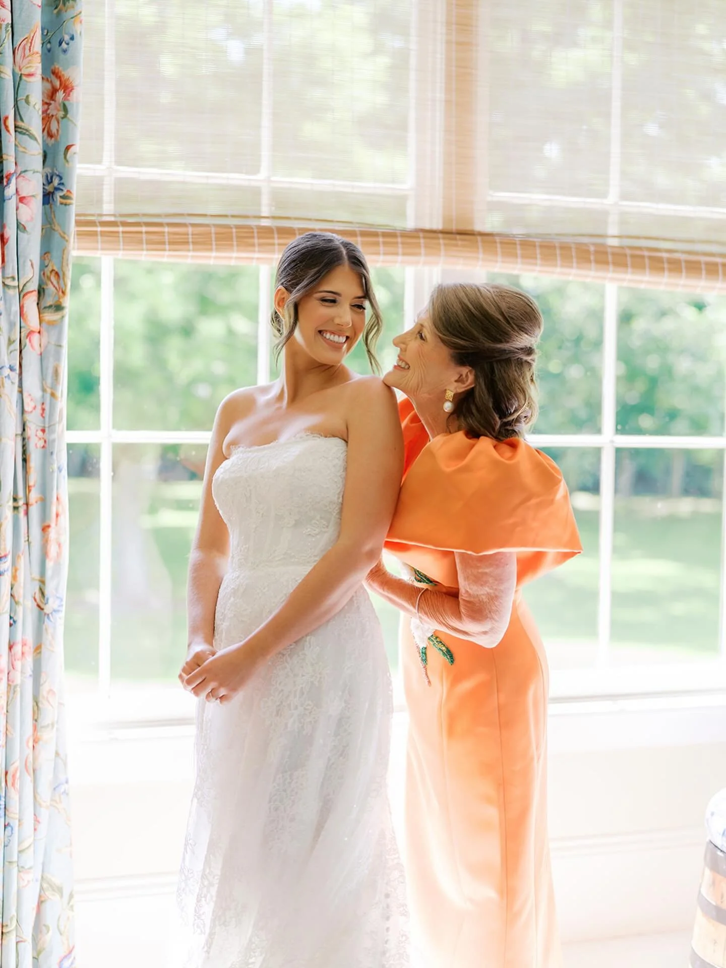 This is always one of my favorite photographed moments of the day. 

 I can&rsquo;t help but think of the many times that mom dressed her daughter in pretty dresses and bows and now, she&rsquo;s helping her into her wedding dress. It all comes full c