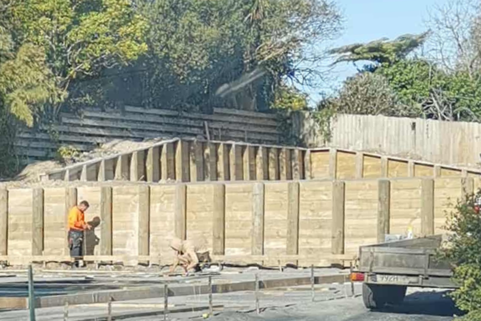 Workers building a wooden fence on a Waikato residential property