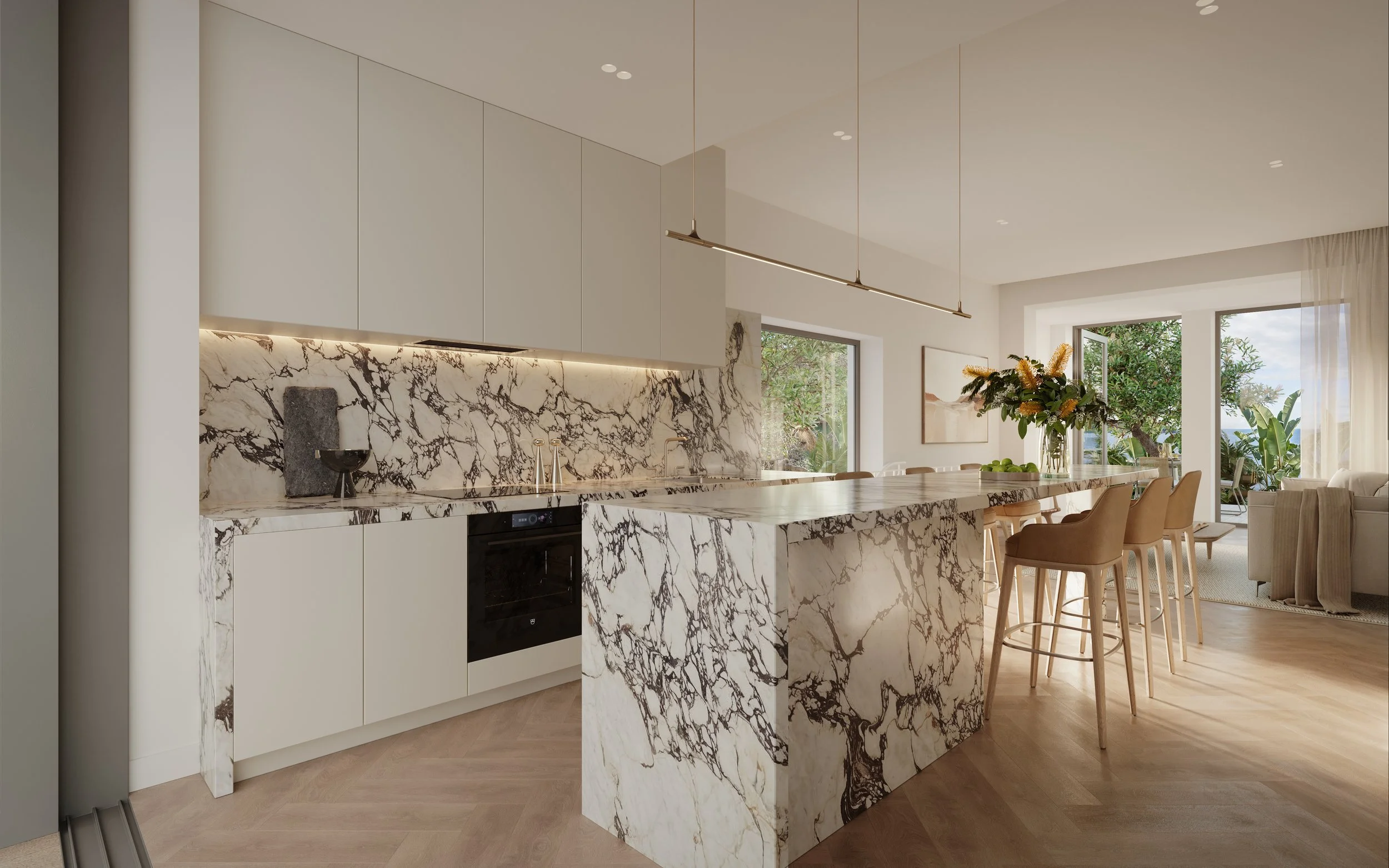Modern kitchen with white cabinets, a marble island, and marble backsplash. Open living space with large windows, a dining table, and a sofa area in the background.