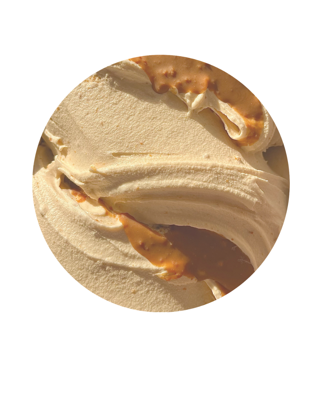 Close-up of a scoop of vanilla ice cream with caramel swirls.