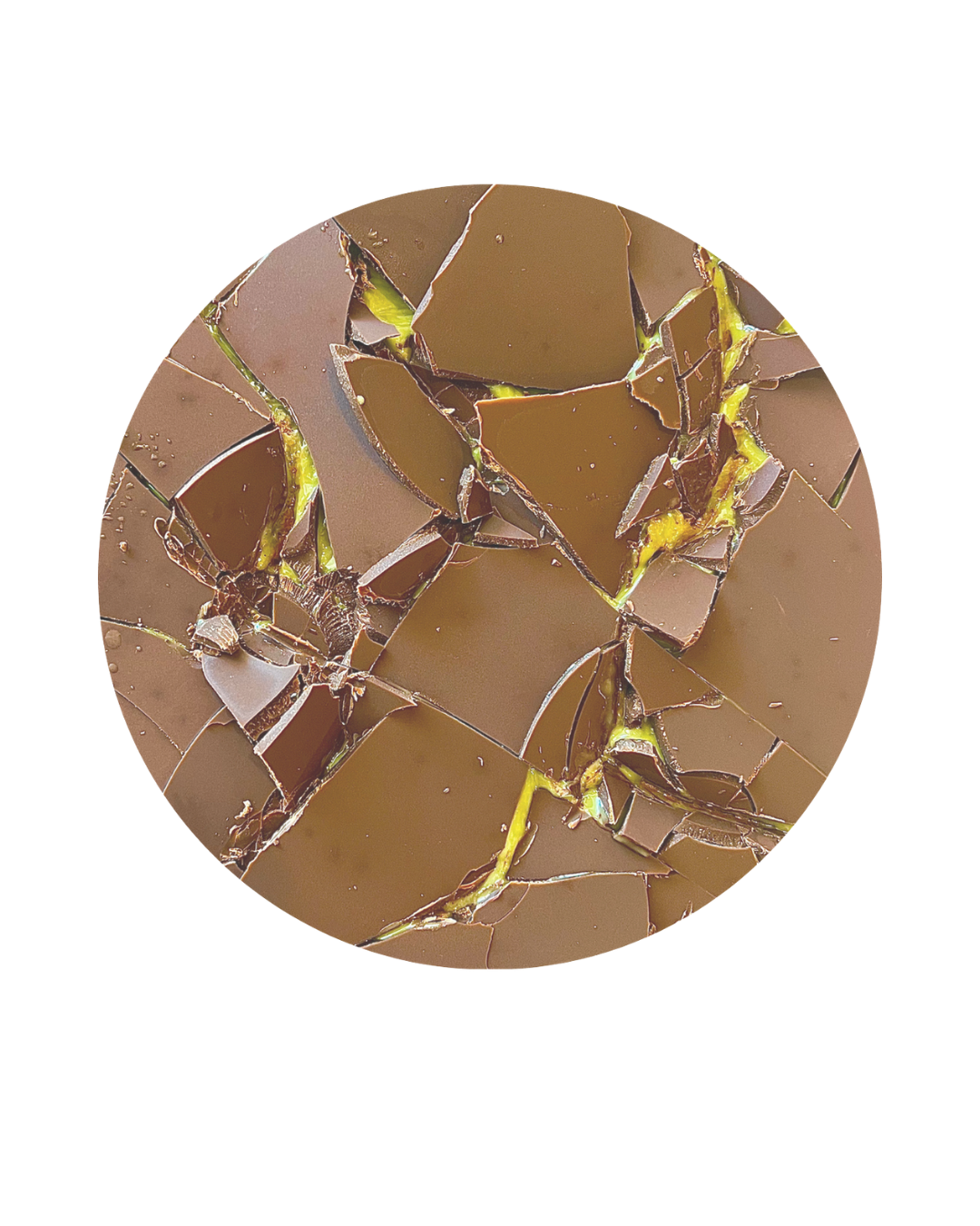 Close-up of broken chocolate pieces with yellow-green filling or topping.