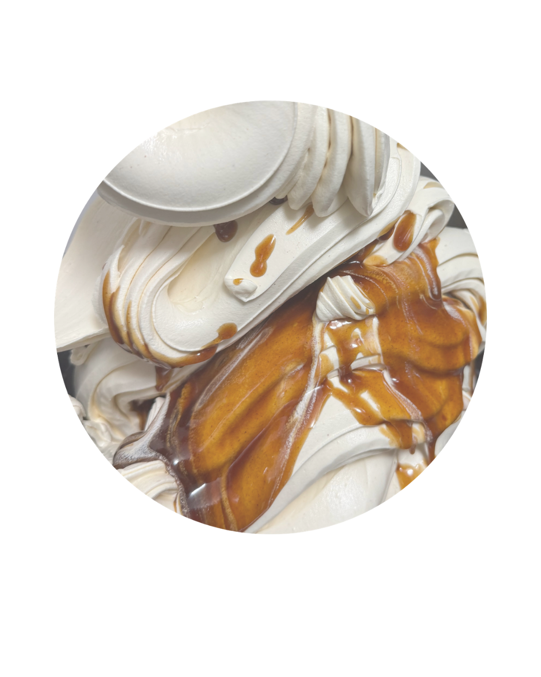 Close-up of a decorated birthday cake with swirls of white frosting, caramel drizzle, and chocolate chips.