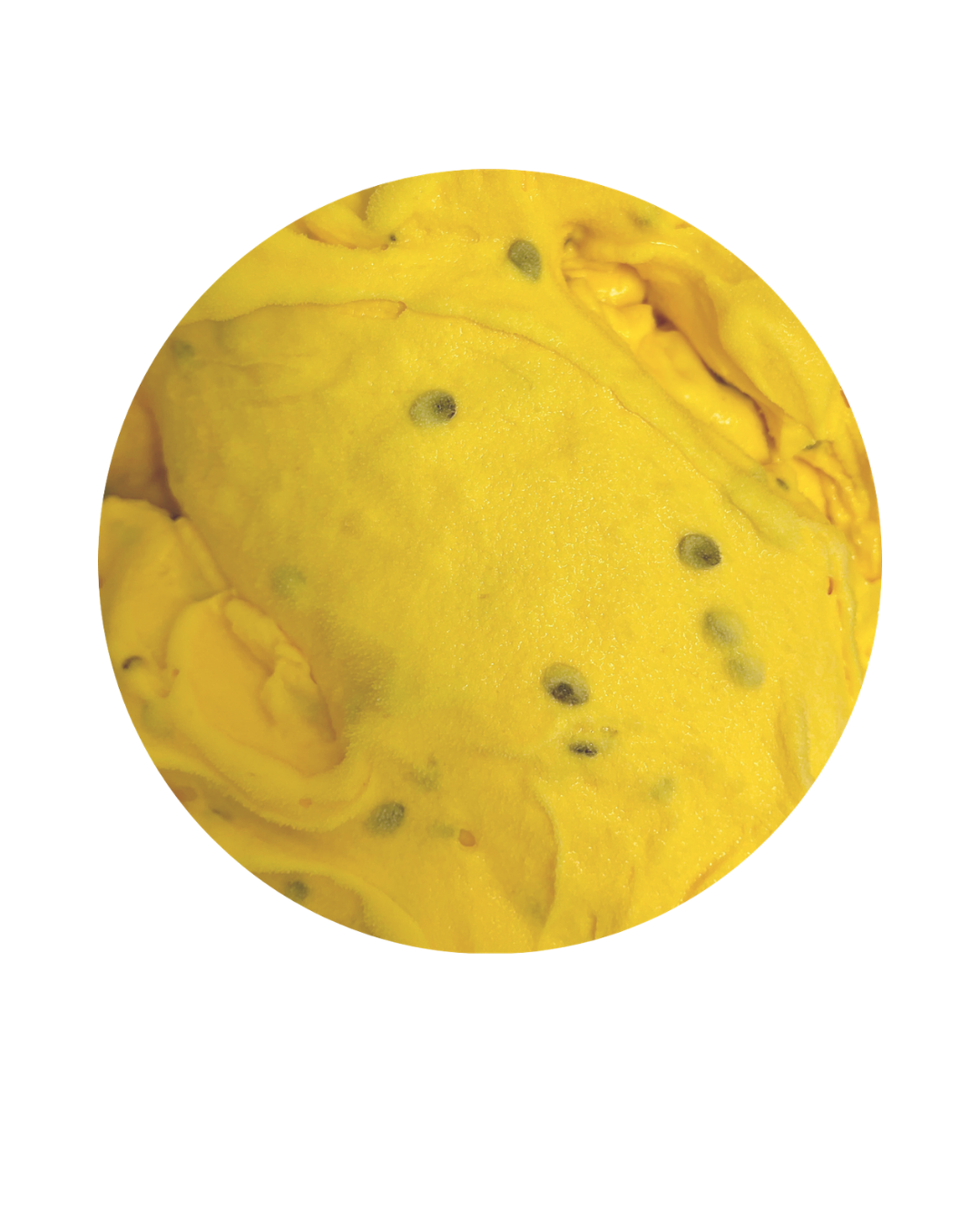 Close-up of a yellow tropical fruit with black seeds.