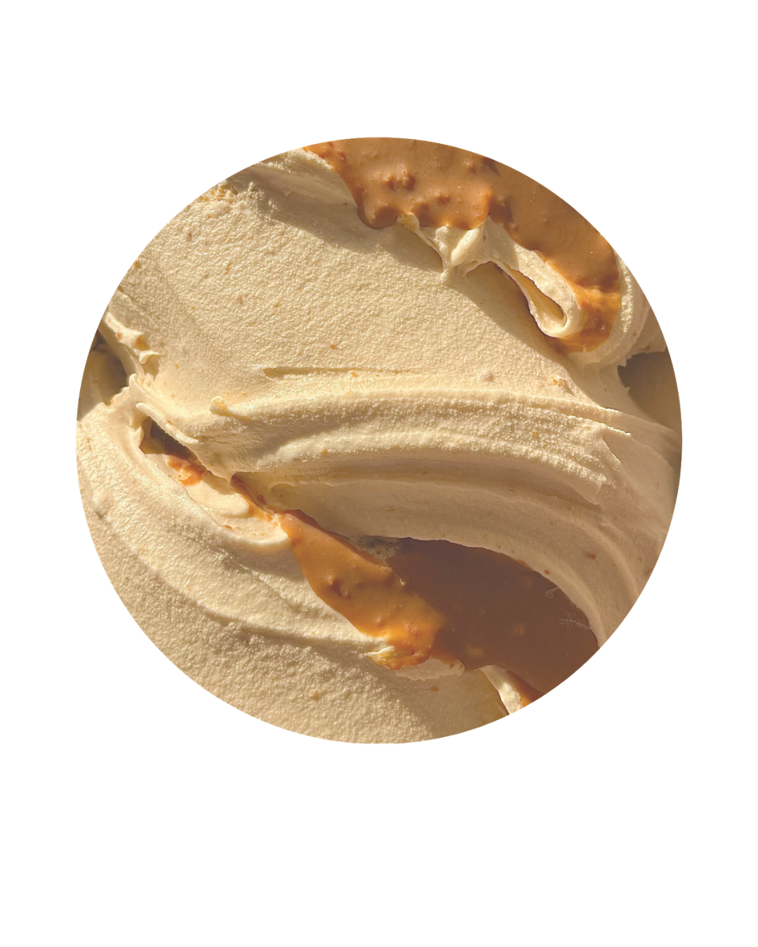Close-up of vanilla ice cream with caramel sauce swirl.