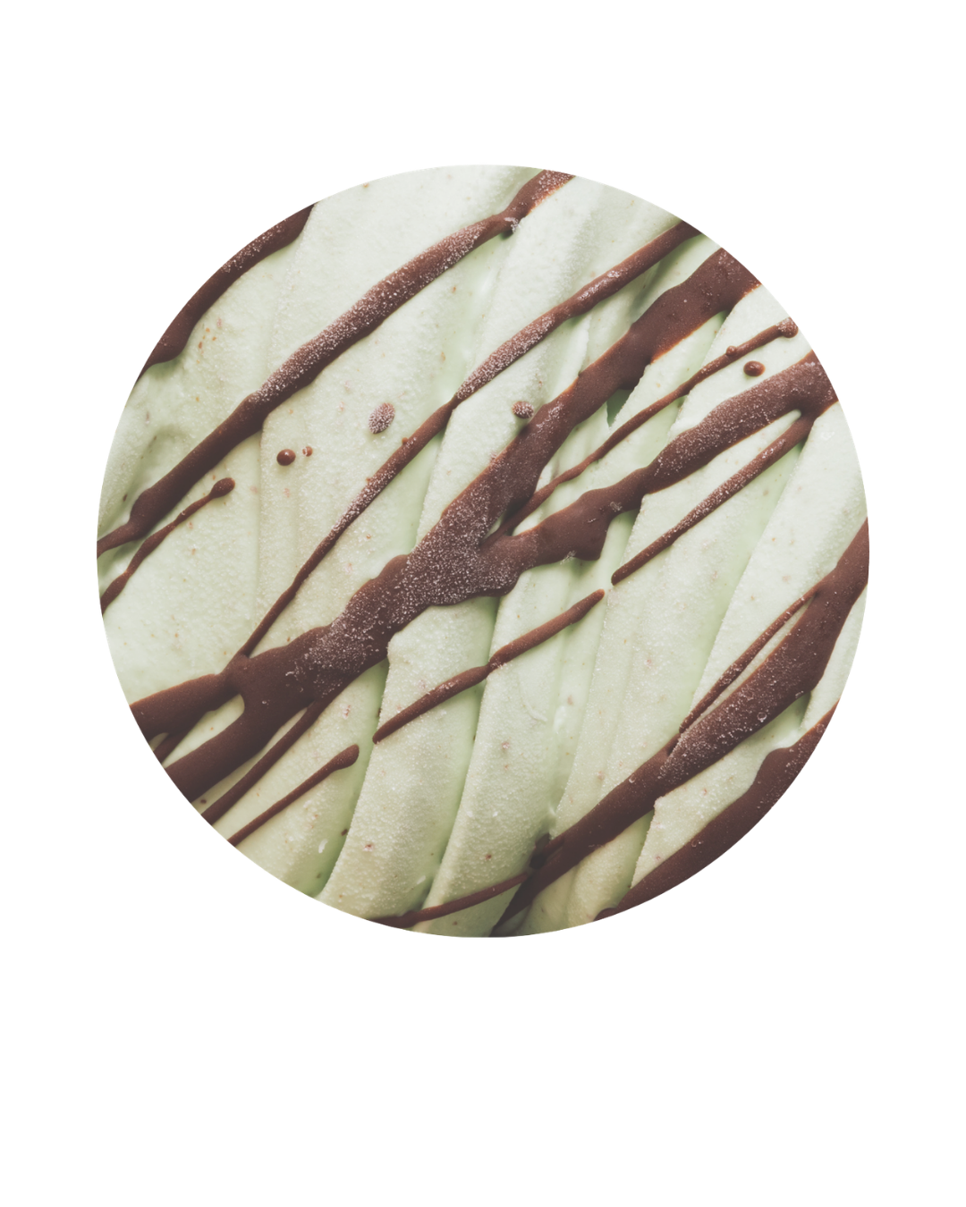 Close-up of a cookie with white icing, drizzled with chocolate and decorated with small bubbles.
