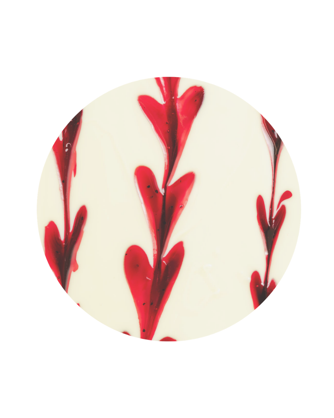 White chocolate disc with red and dark brown swirled pattern