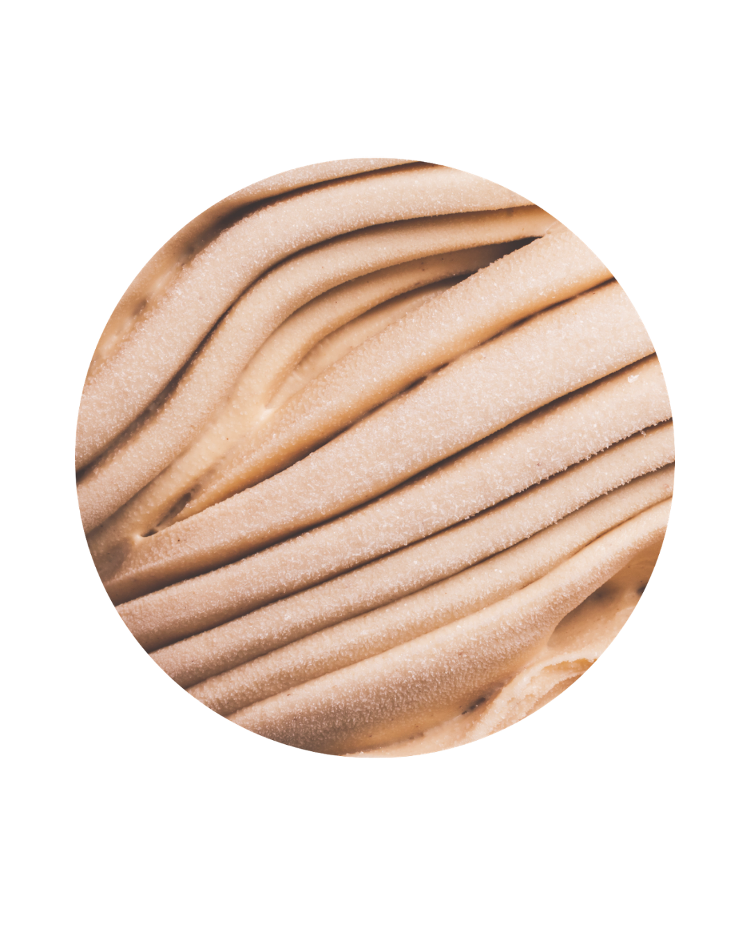 Close-up of beige-colored, piped frosting with ridges and a slightly textured surface.