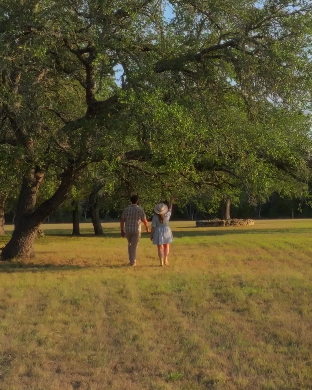 Guests walking beneath the oak trees on The Gathering property in Wimberley, Texas.