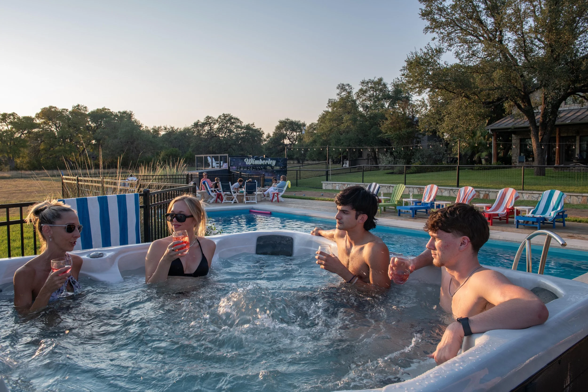 People relaxing together in the hot tub at sunset at The Gathering in Wimberley, Texas.