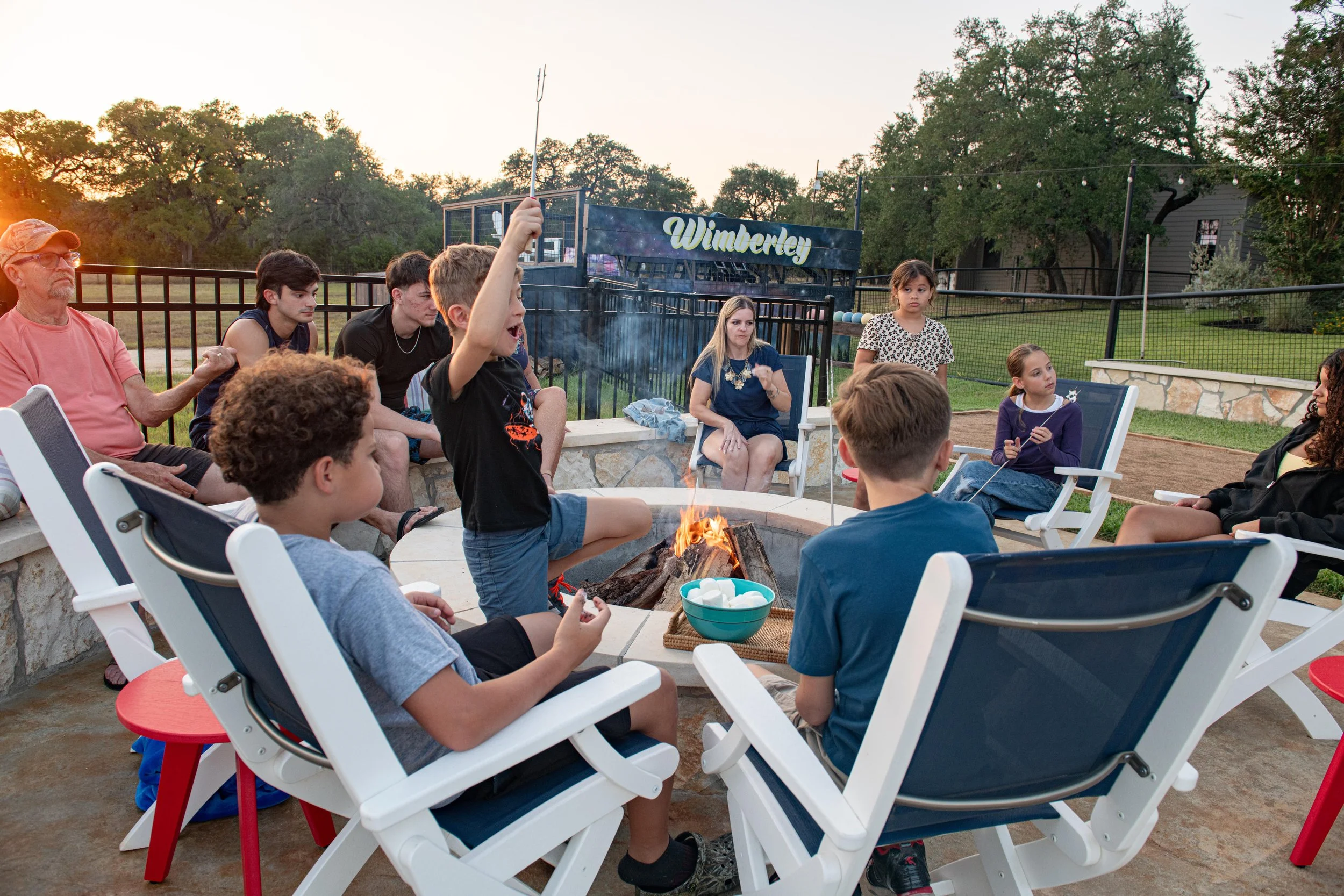 Family gathered around the fire pit at The Gathering in Wimberley, Texas.
