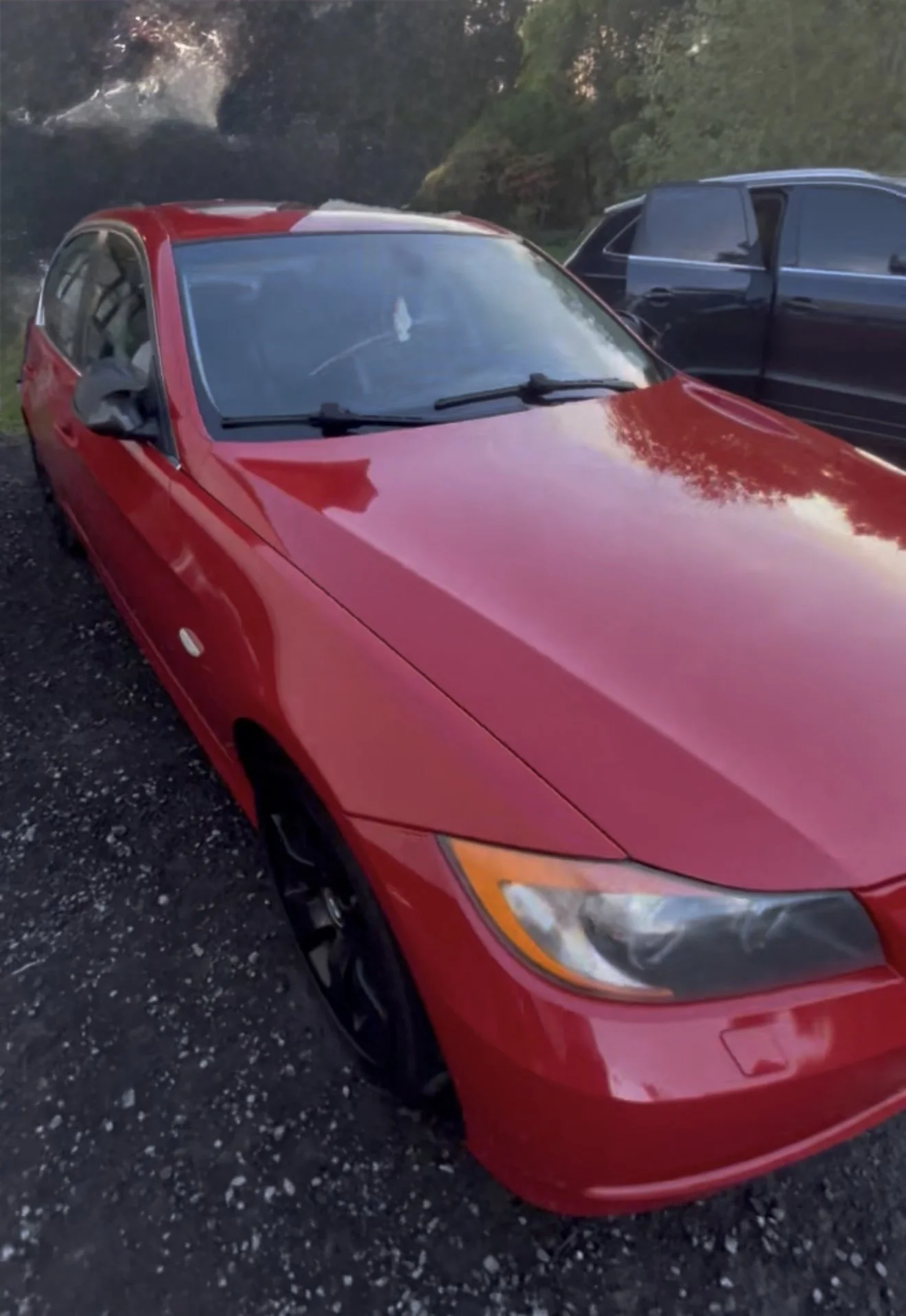 A deep, glossy finish on a red BMW after a professional clay bar treatment and ceramic sealant application by Results Detailing and Pressure Washing in Ithaca, NY.