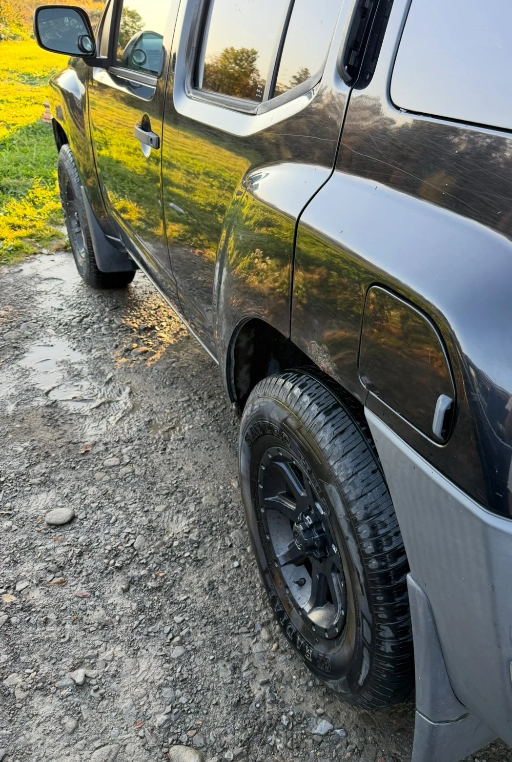 Mirror-like finish on the side of a black Nissan SUV after a full exterior detail and wax by Results Detailing and Pressure Washing in Trumansburg, NY in the Finger Lakes.