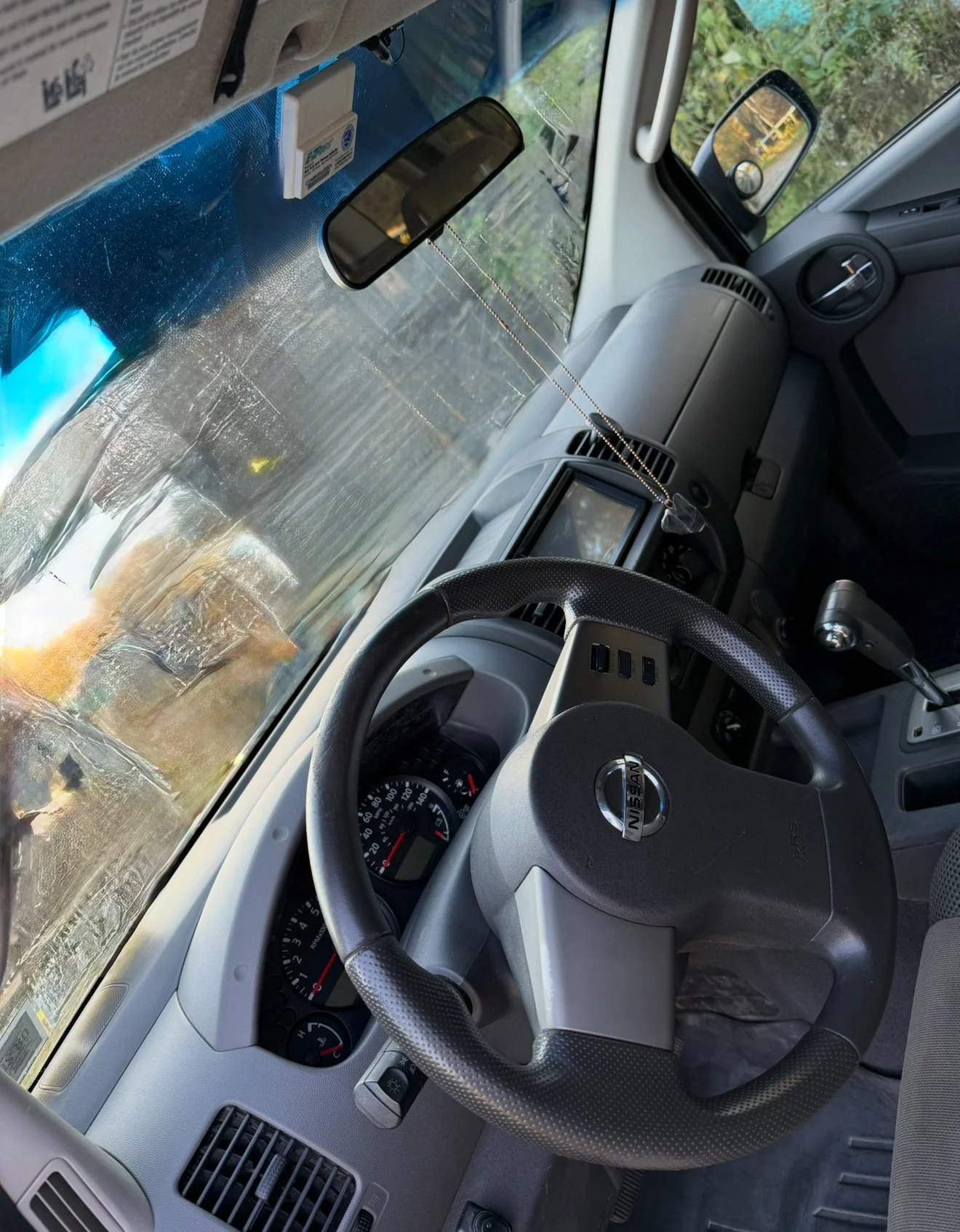 A perfectly cleaned and conditioned Nissan SUV dashboard and steering wheel after a full interior detail by Results Detailing and Pressure Washing in Trumansburg, NY Tompkins county.